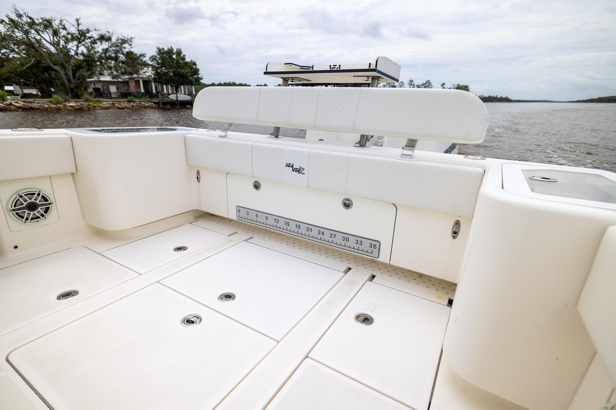 2019 SeaVee 322Z boat interior with seating and storage, on a calm waterway.