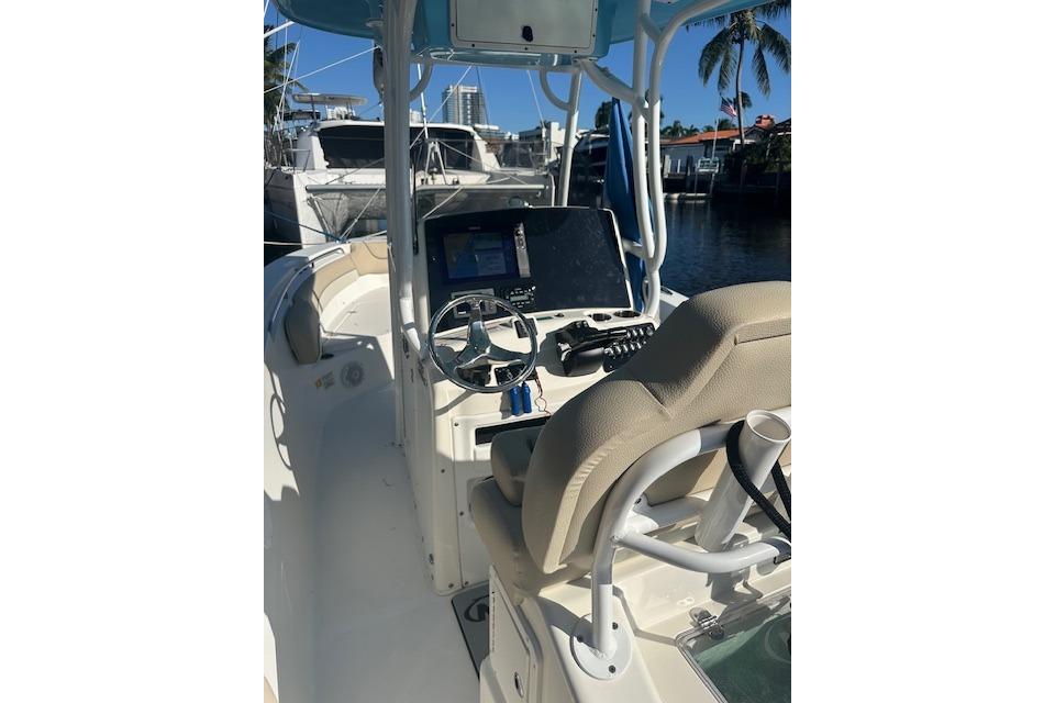 2018 NauticStar 2602 Legacy boat interior with steering wheel and navigation equipment.