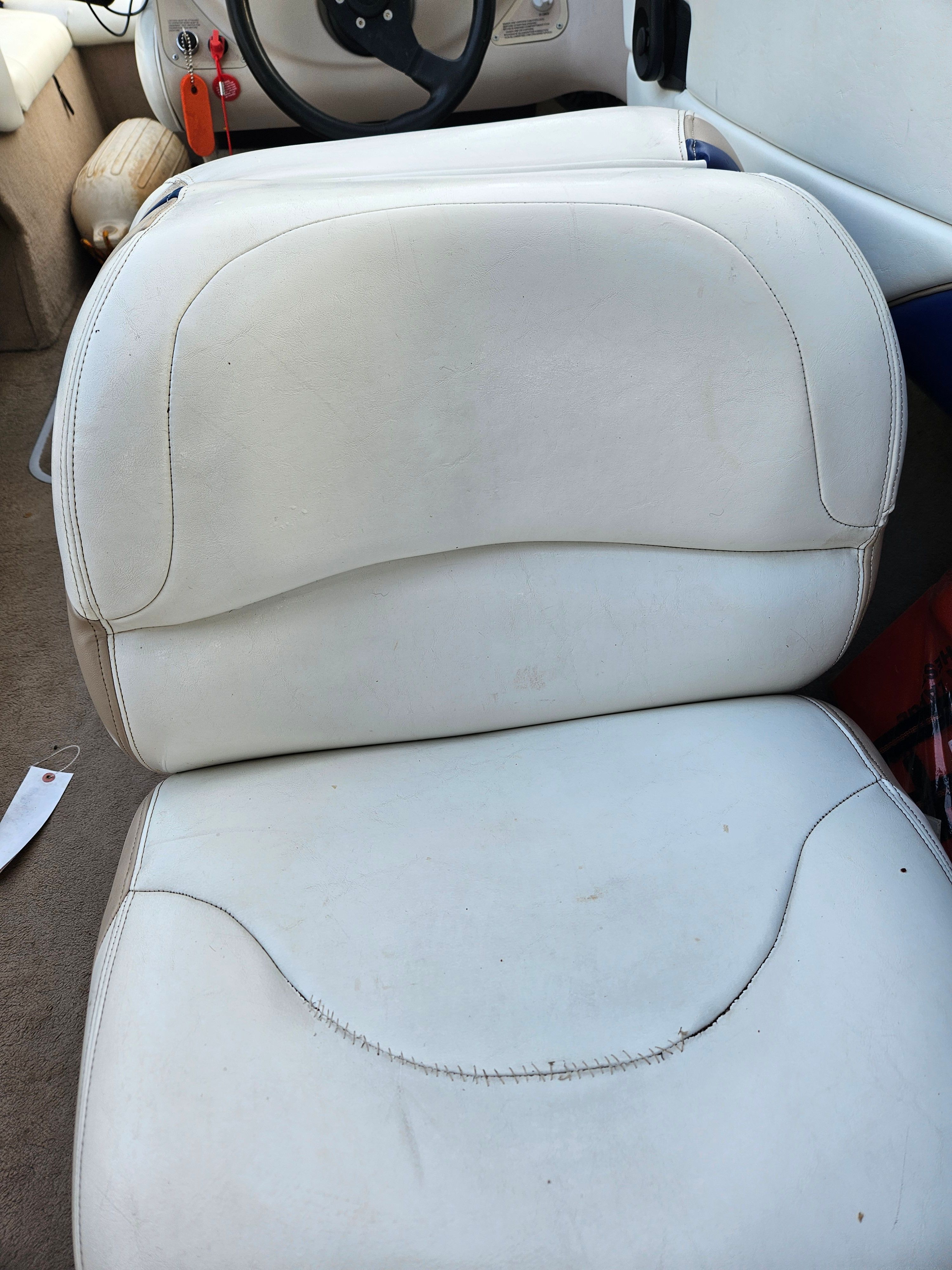 1996 Wellcraft Excel boat with white seat upholstery.