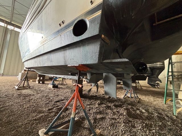 A 2004 Meridian 341 Sedan is supported on stands in a warehouse.