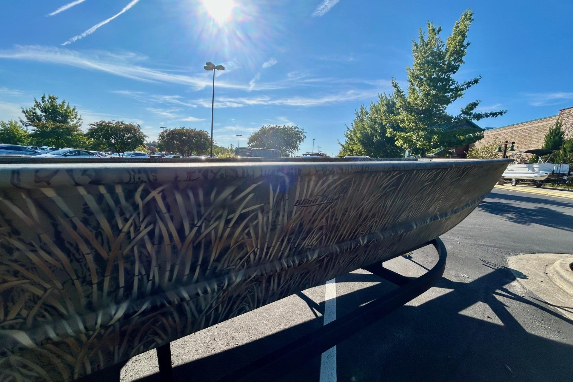 2026 Tracker Grizzly 2072 Utility boat with camouflage design under bright sunlight.
