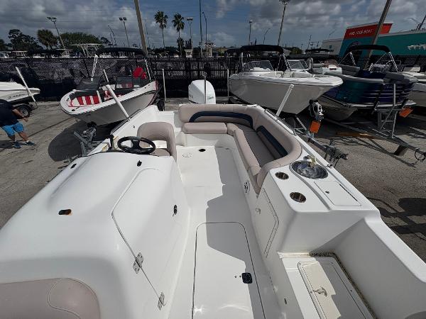 2014 Hurricane SunDeck Sport 232 OB boat with spacious seating and steering console.