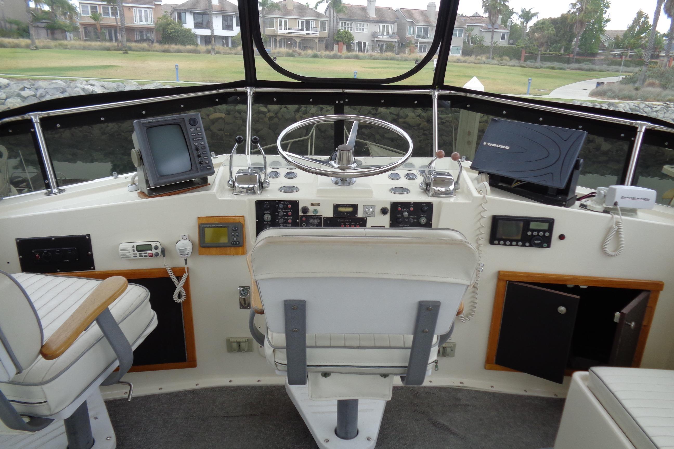Cockpit of 1981 Hatteras 48 Cockpit Motor Yacht with navigation equipment and steering wheel.