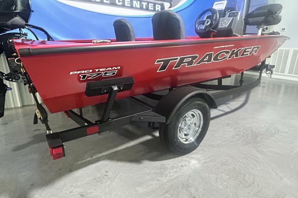 2026 Tracker Pro Team 175 Crappie Edition boat in showroom, red exterior, on trailer.