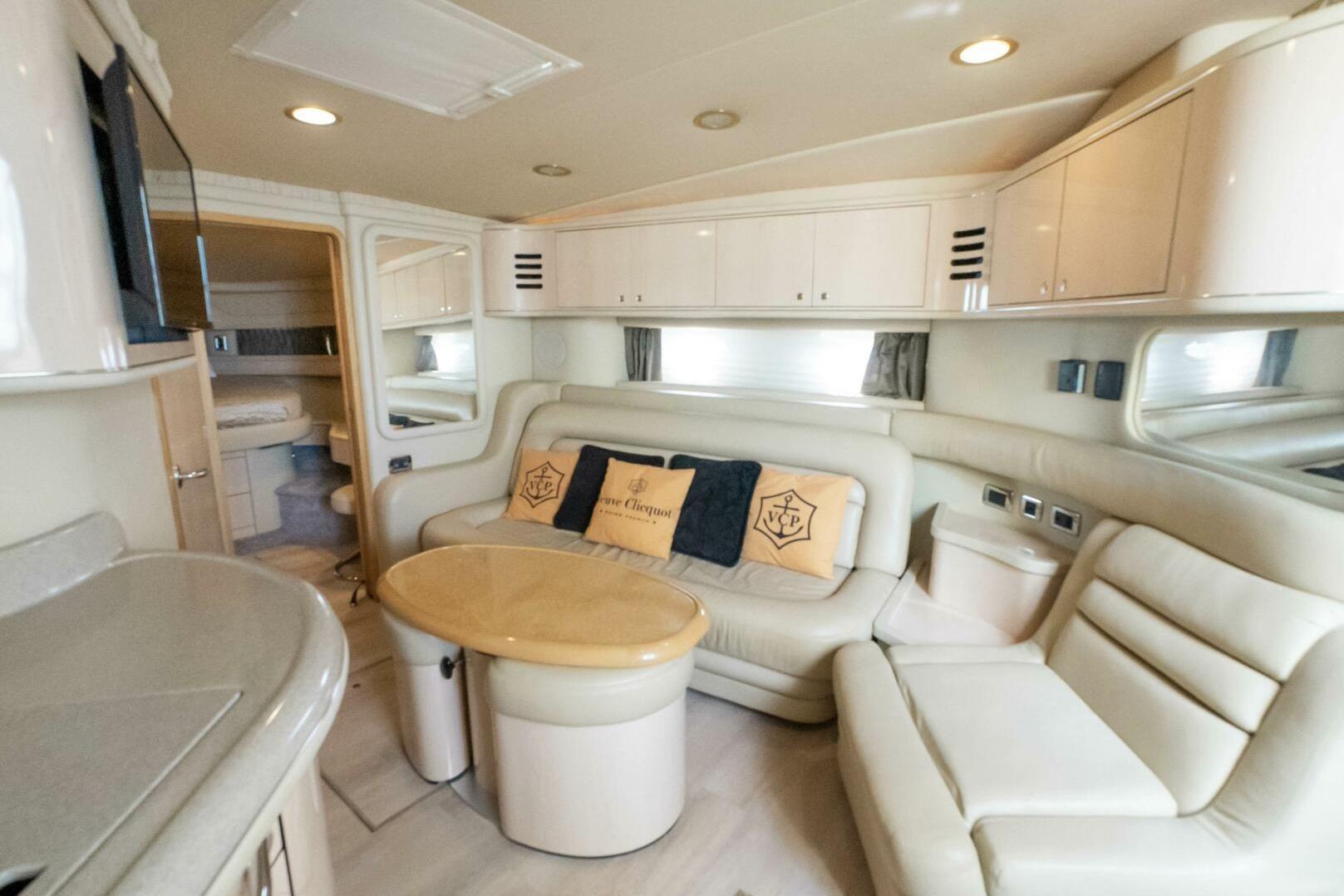 Luxurious interior of 2003 Sea Ray Sundancer 460 yacht with plush seating and elegant decor.