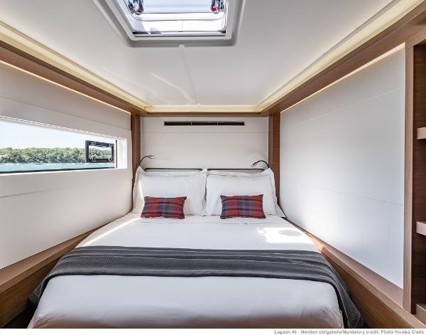 Luxurious bedroom interior of 2025 Lagoon 46 ICONIC yacht with modern design and natural light.