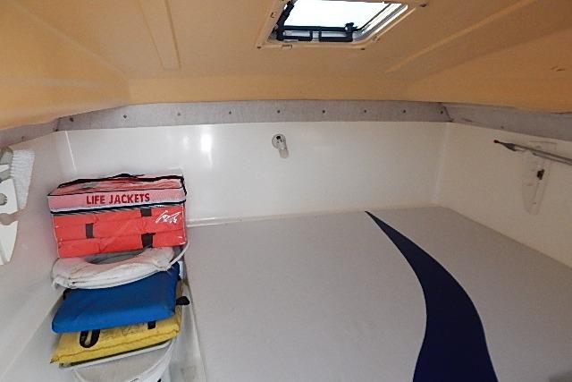 2003 World Cat 270 EC cabin interior with life jackets and storage space.