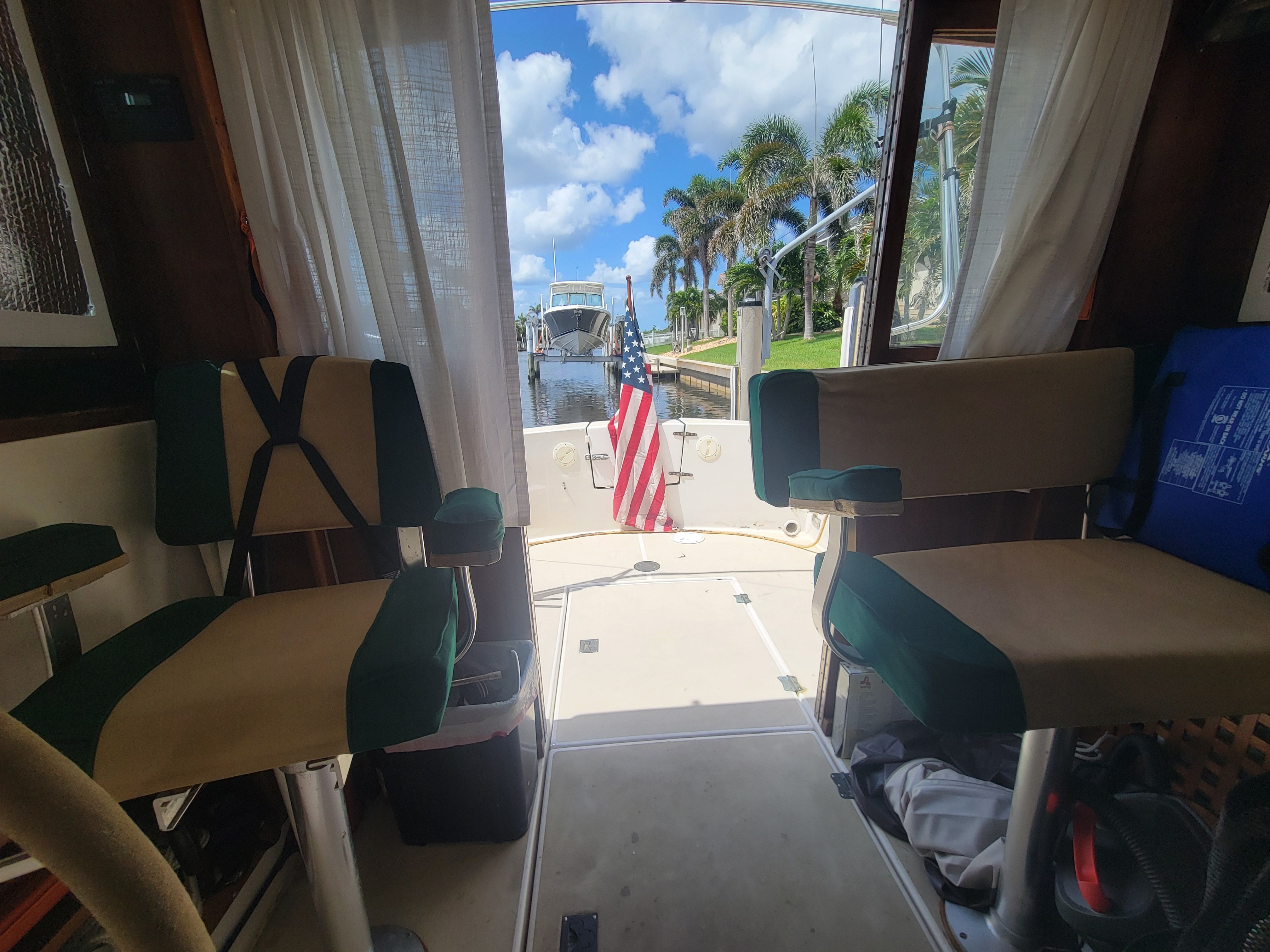 Interior view of a 1989 Cape Dory MS300, overlooking the harbor and palm trees.