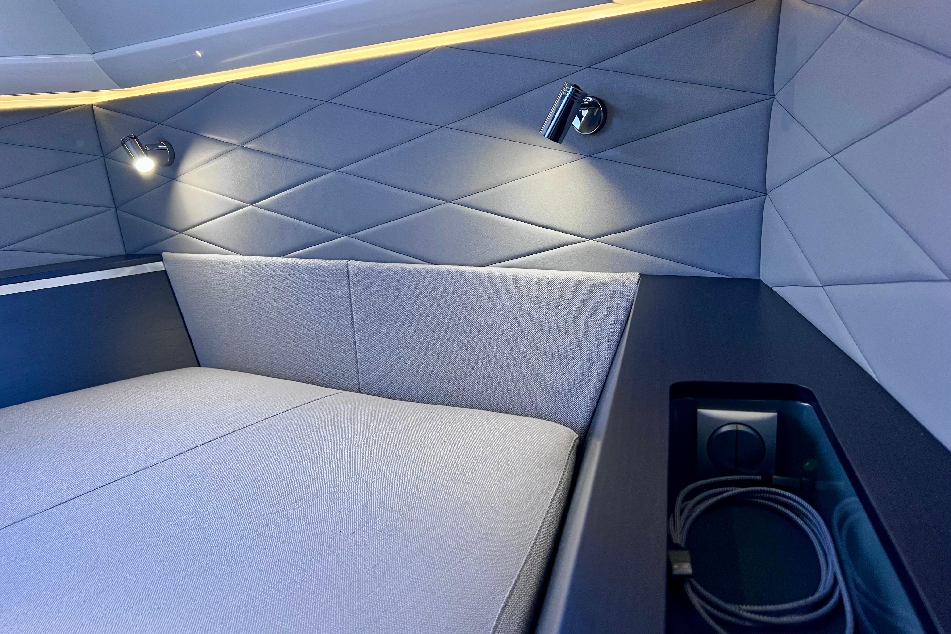 Luxurious interior cabin of 2022 Windy SR 44 BLACKHAWK yacht with modern lighting and quilted walls.