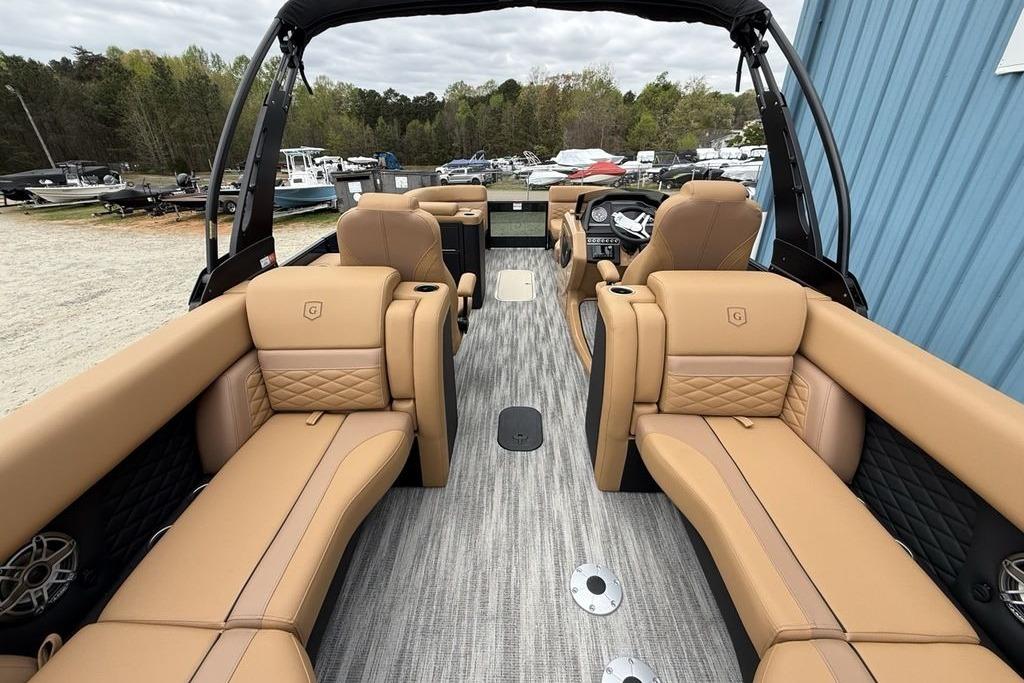 Luxurious interior of 2026 Godfrey Monaco 235 SFLC iMPACT pontoon boat with tan seating.