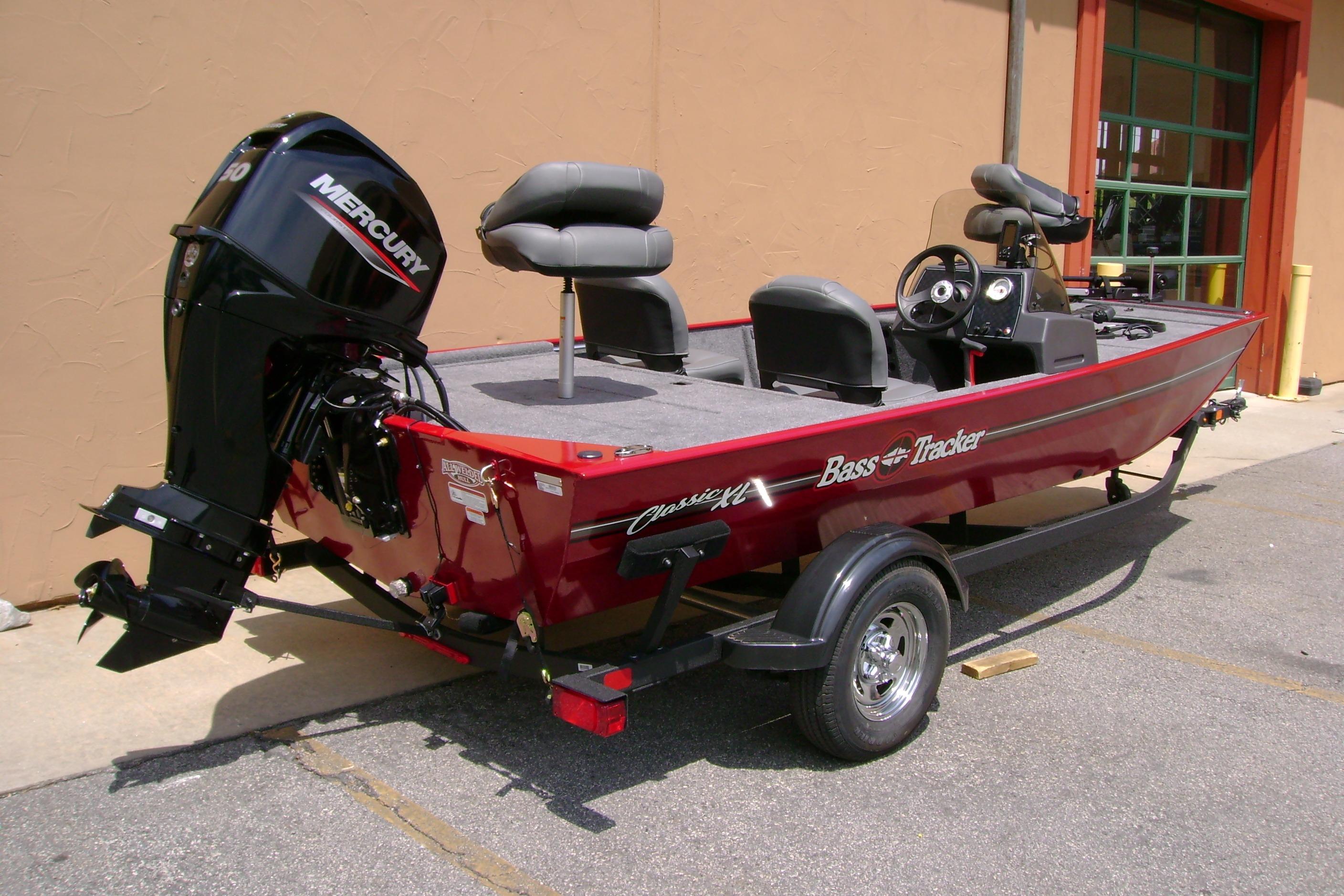 2026 Tracker Bass Tracker Classic XL boat with Mercury engine, parked outdoors.
