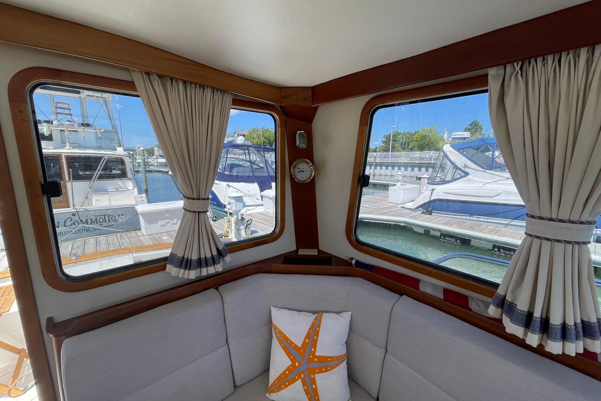Interior of 1999 Legacy Yachts 40 Sedan with marina view through windows.