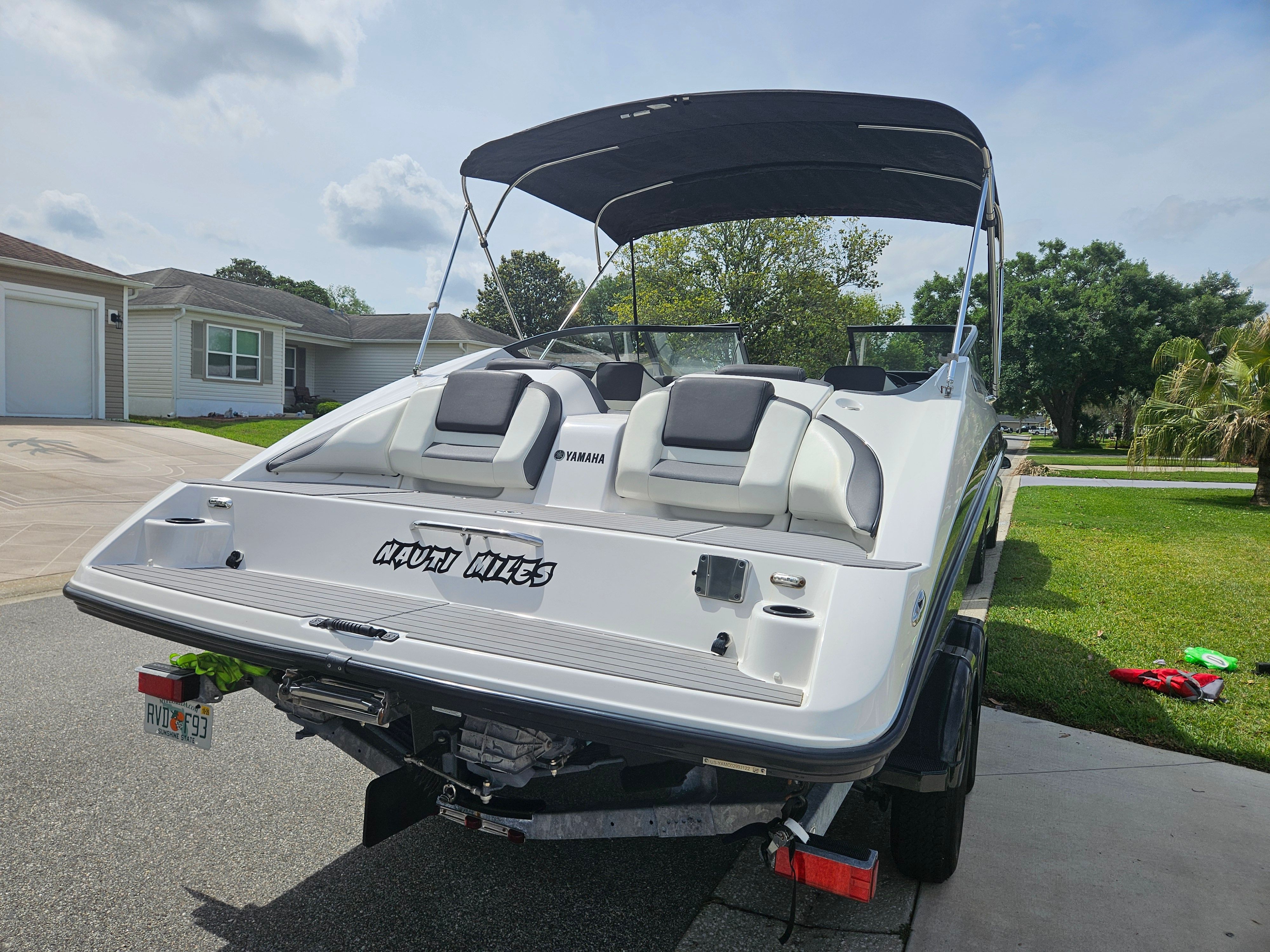 2022 Yamaha SX210 boat on trailer in residential area.