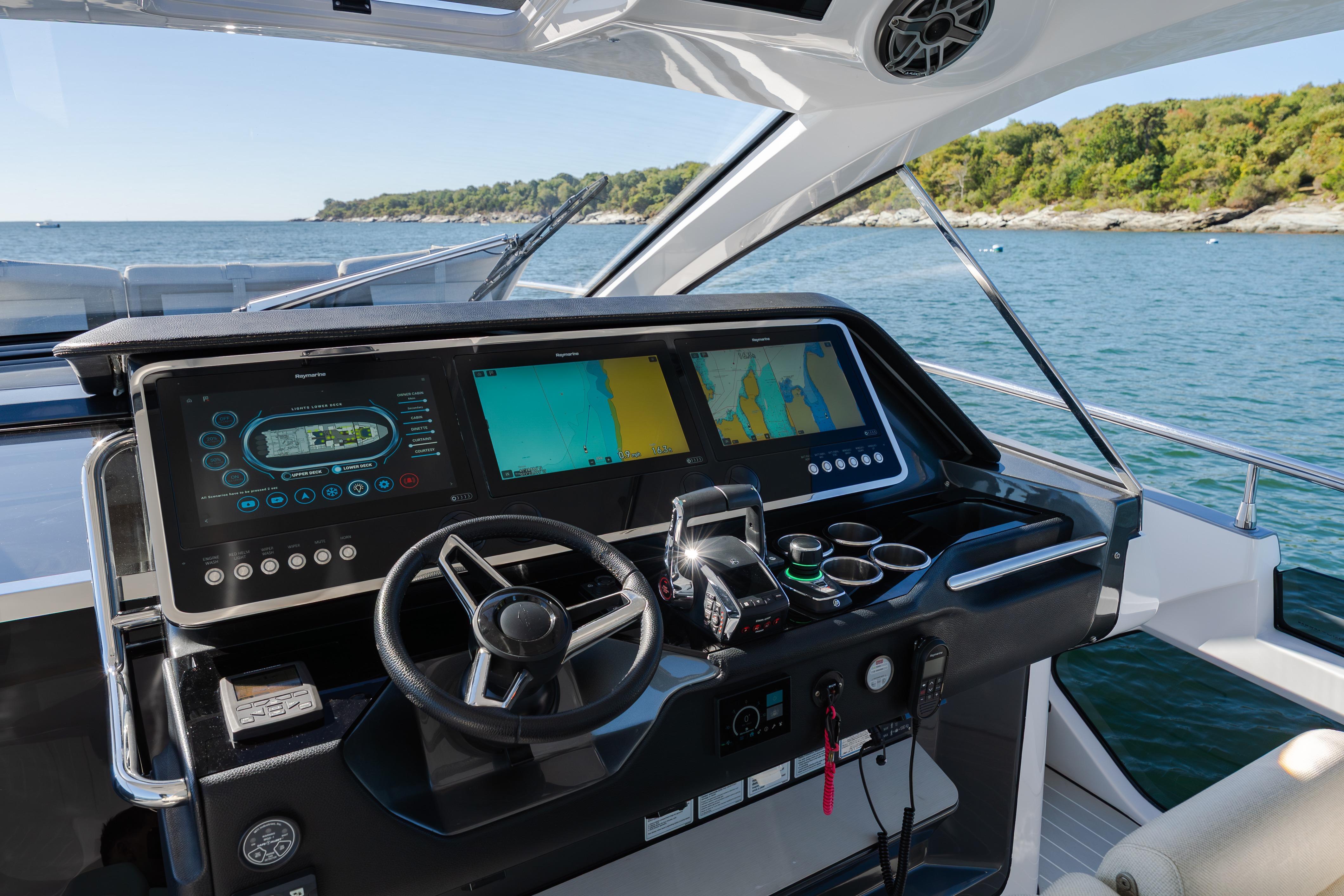 Cockpit of 2023 Azimut Verve 47 yacht with advanced navigation displays and steering wheel.