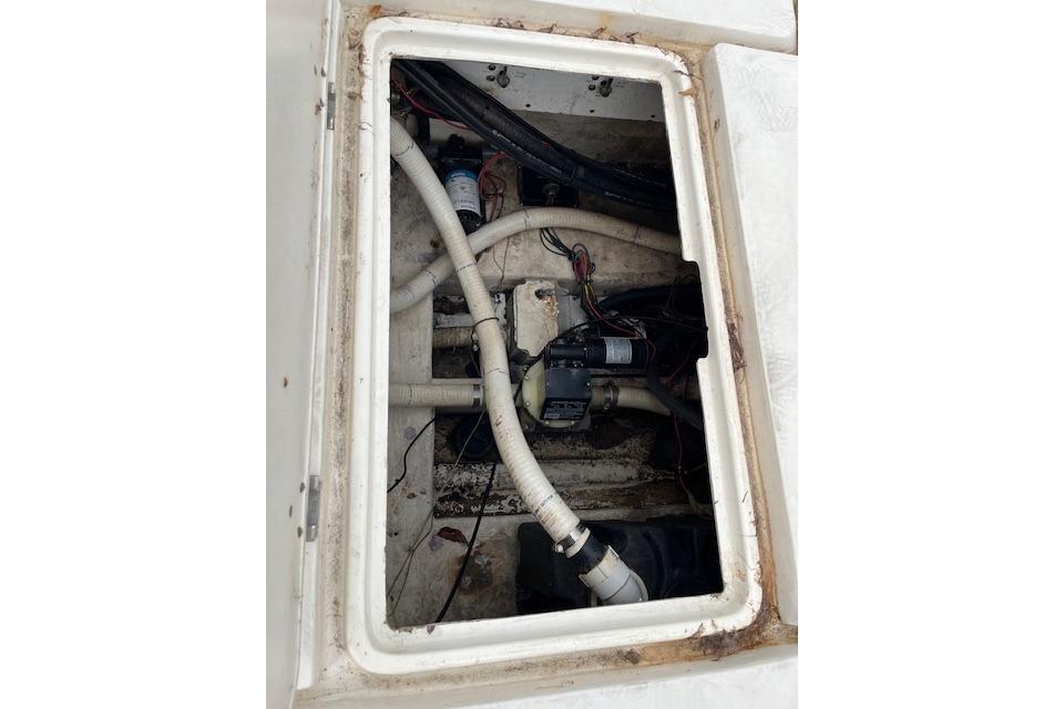 Bilge area of a 2001 Fountain 38 Center Console boat, showing pipes and wiring.