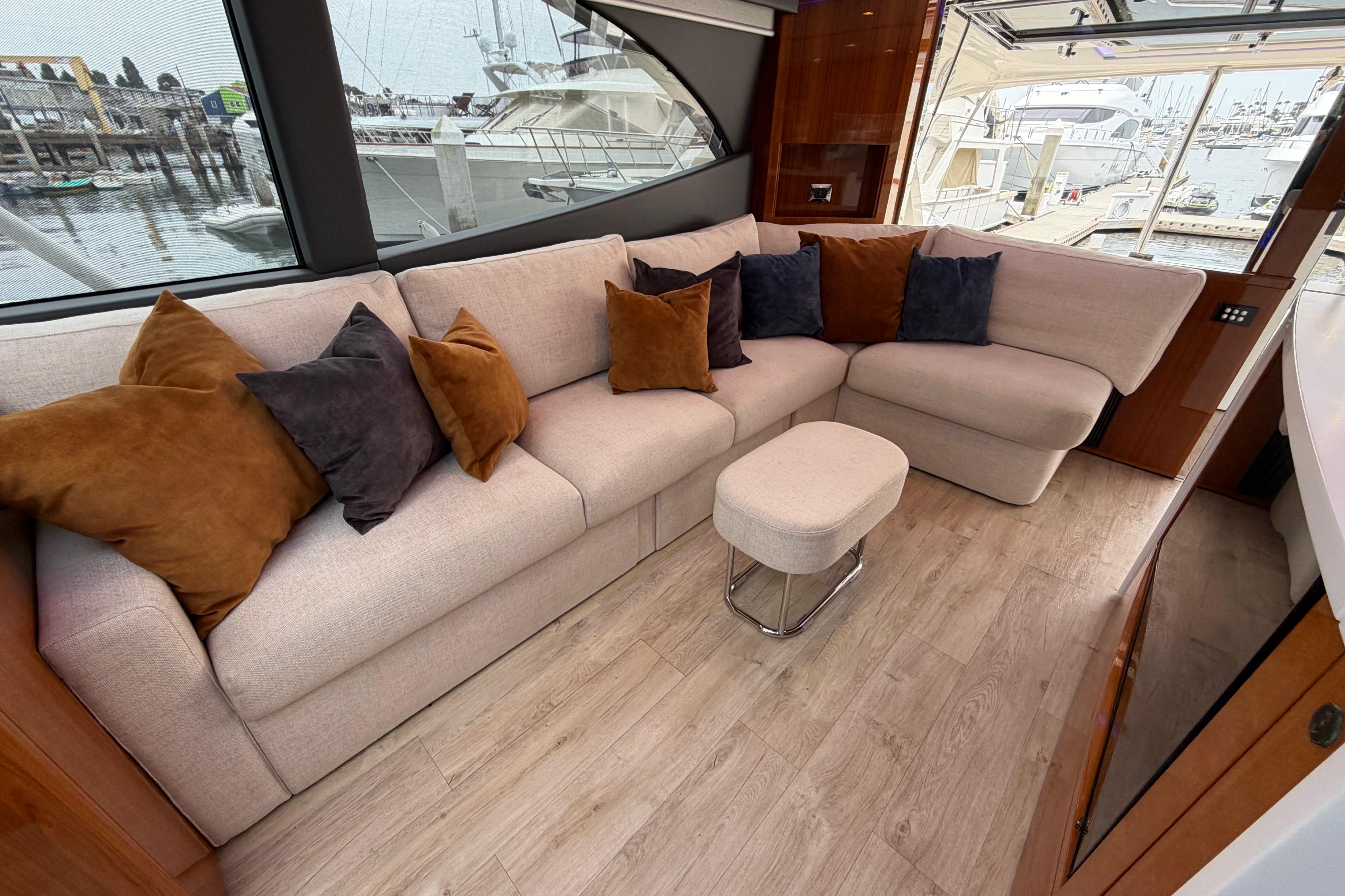 Luxurious interior of 2023 Riviera 645 SUV yacht with plush seating and elegant decor.