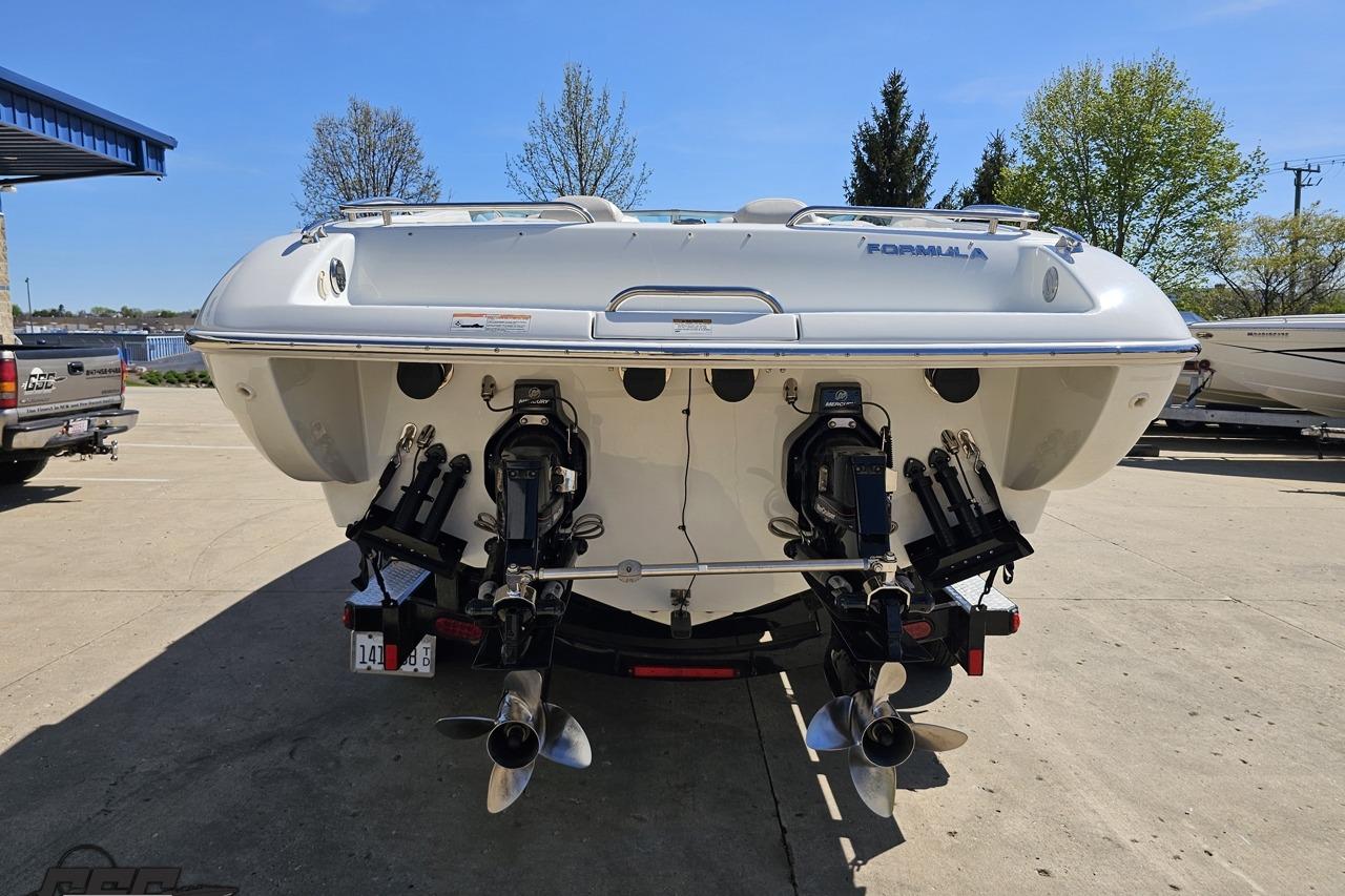2014 Formula 292 FASTech boat rear view with dual propellers, parked outdoors.