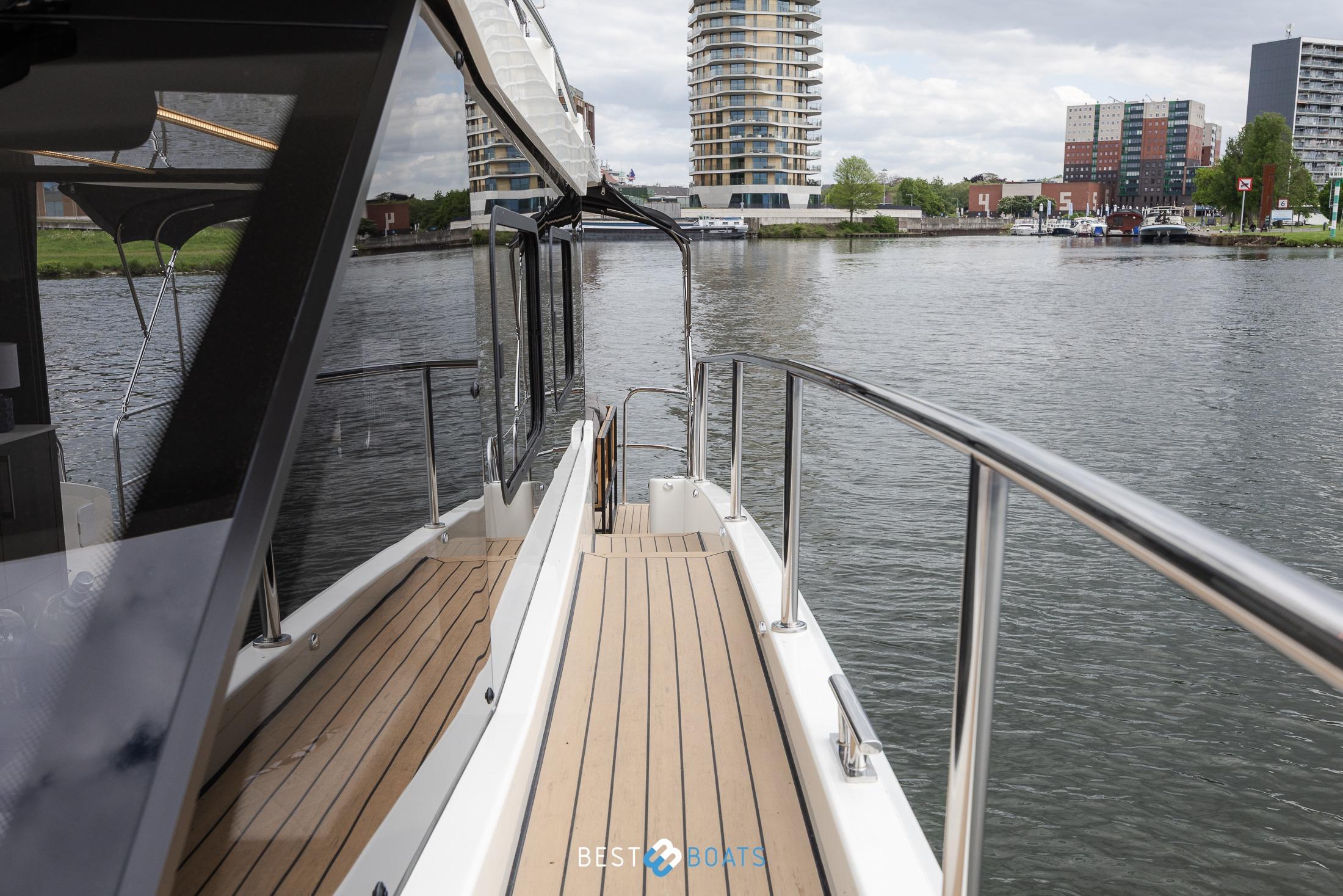 2023 Cobra Yachts Futura 36 Premium Fly on a serene waterfront.