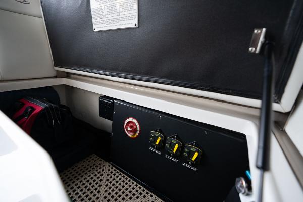 Control panel inside 2016 Regal 28 Express boat cabin, featuring switches and storage.