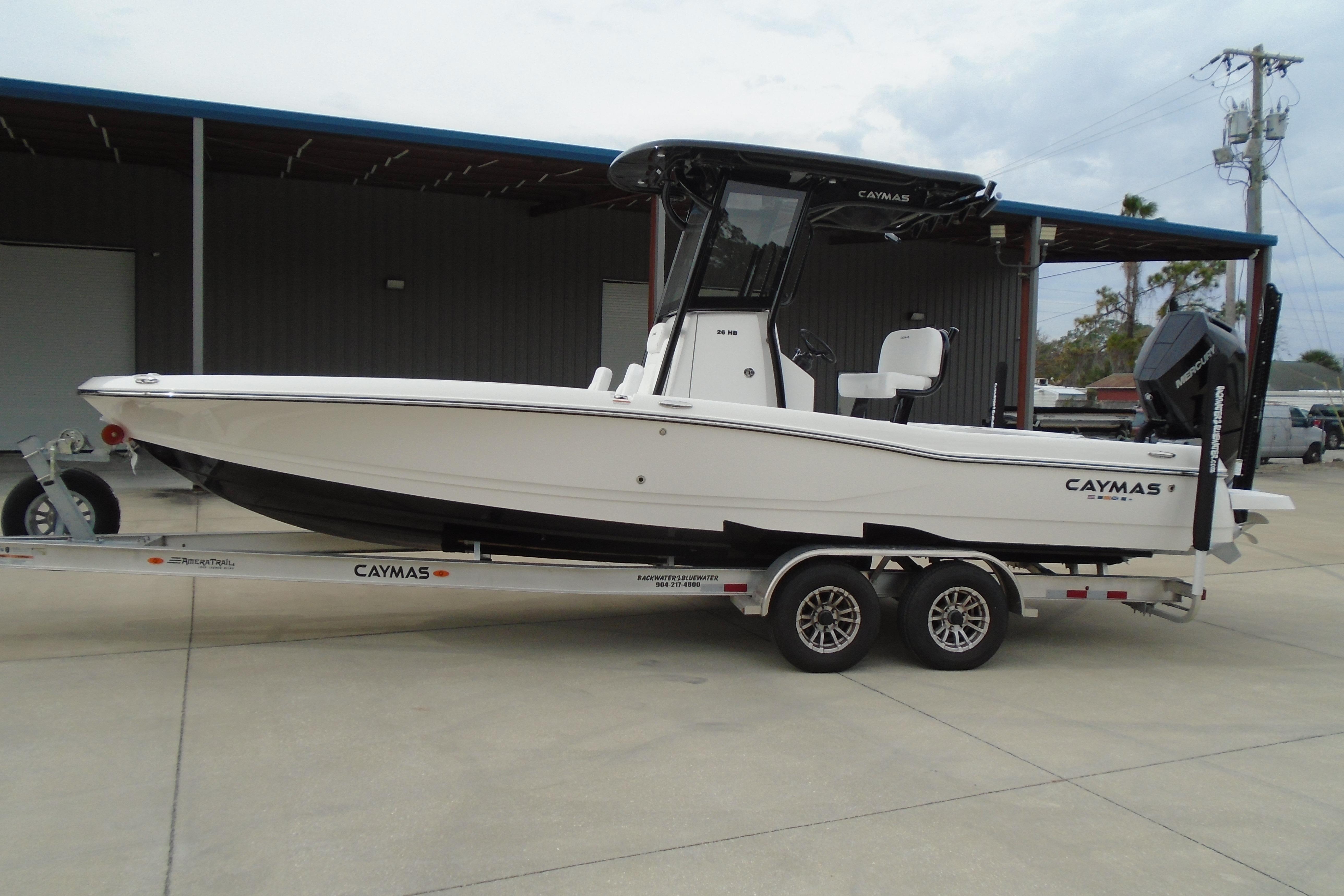 2026 Caymas 26 HB boat on trailer, parked outdoors, side view.