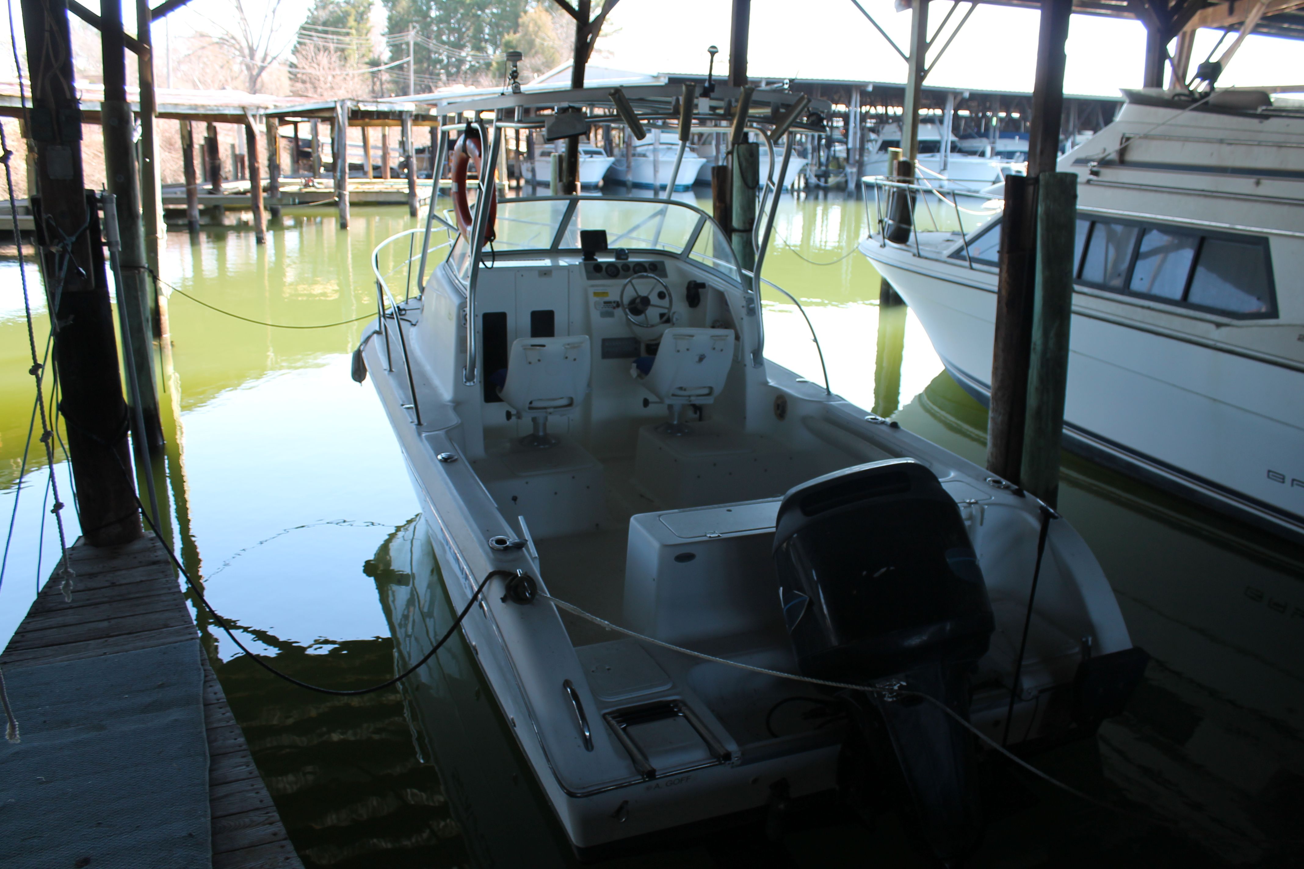 2004 Sea Fox 230 Walk Around boat docked in marina.