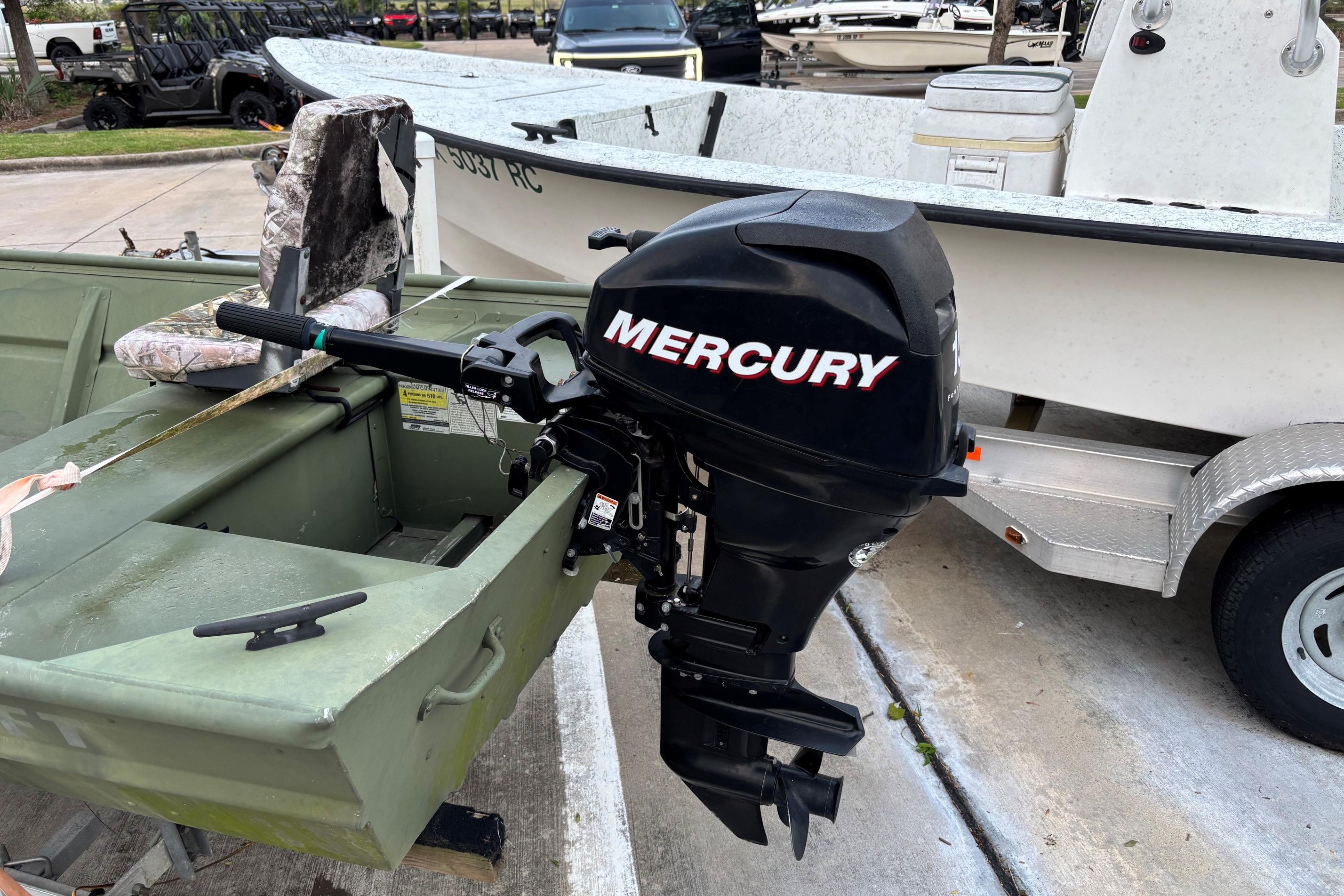 2011 Alumacraft 1542 Jon boat with Mercury outboard motor, parked on a trailer.