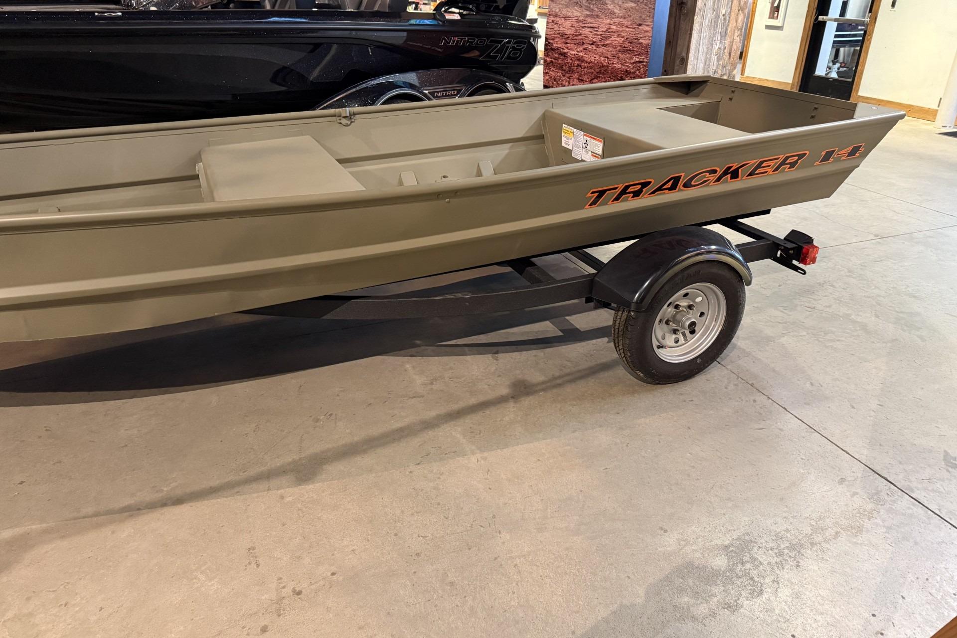 2026 Tracker Grizzly 14 Jon boat on trailer in showroom.