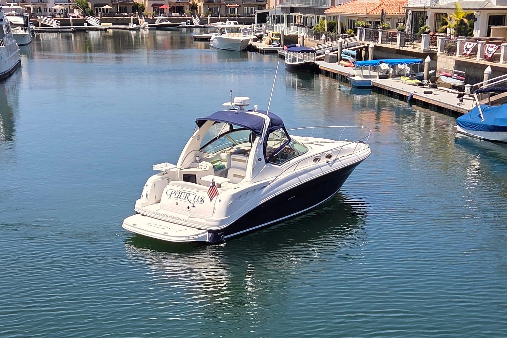 2006 Sea Ray Sundancer 320 yacht docked in a serene marina setting.