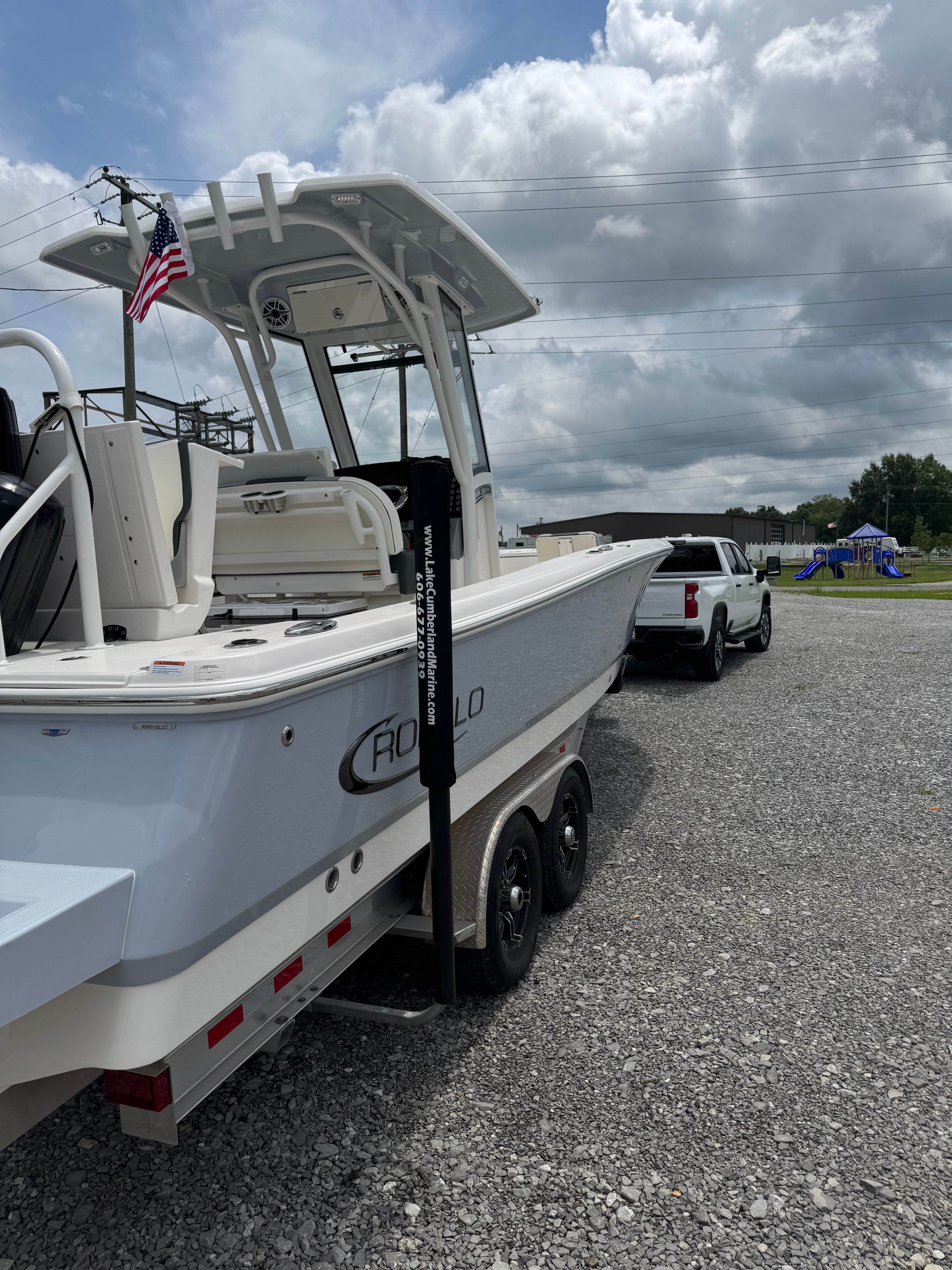 A 2023 Robalo 266 Cayman boat on a trailer, ready for transport.