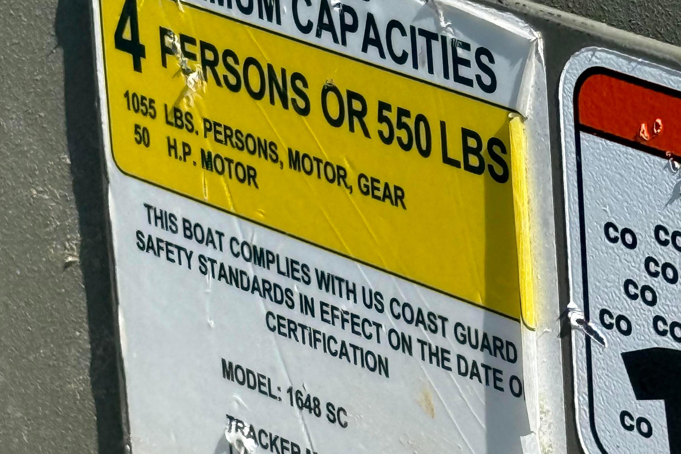 Sticker on 2019 Tracker Grizzly 1648 SC showing capacity and safety compliance.