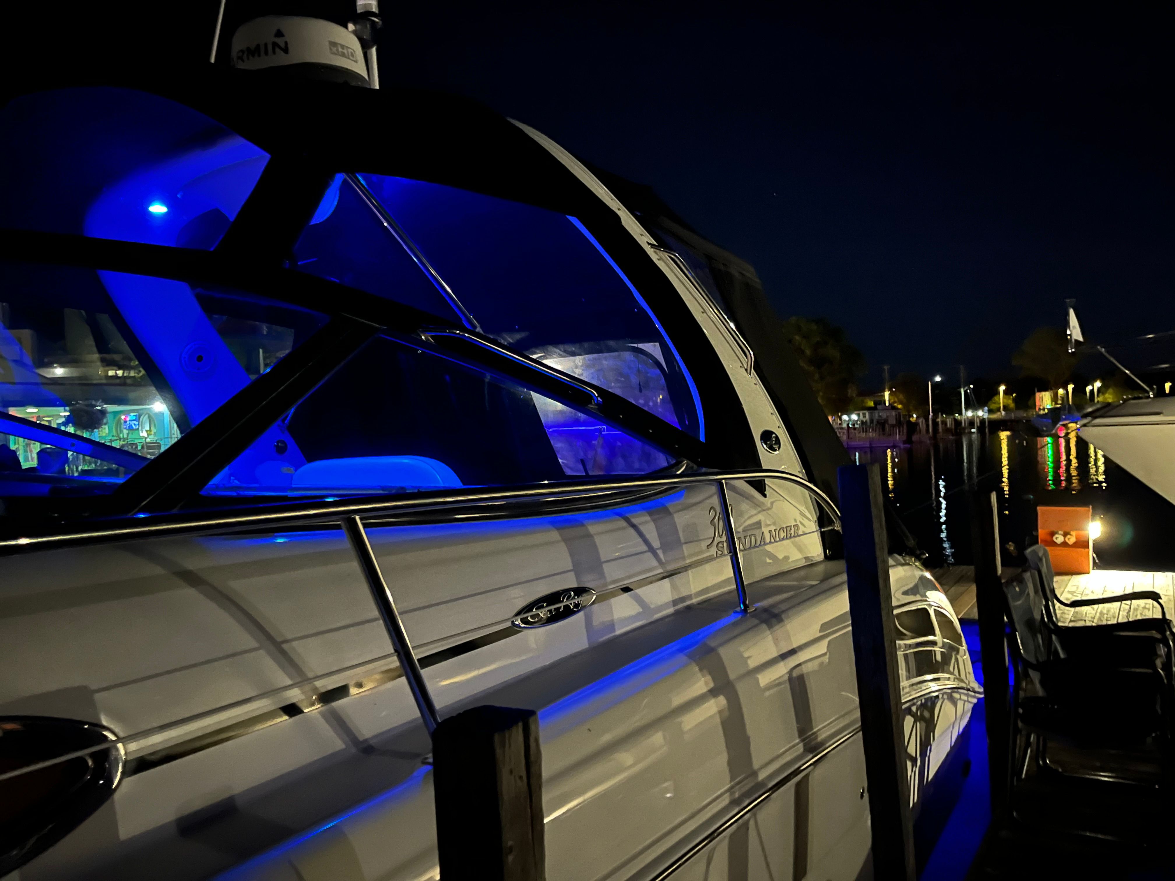 2005 Sea Ray Sundancer yacht at night with blue lighting.