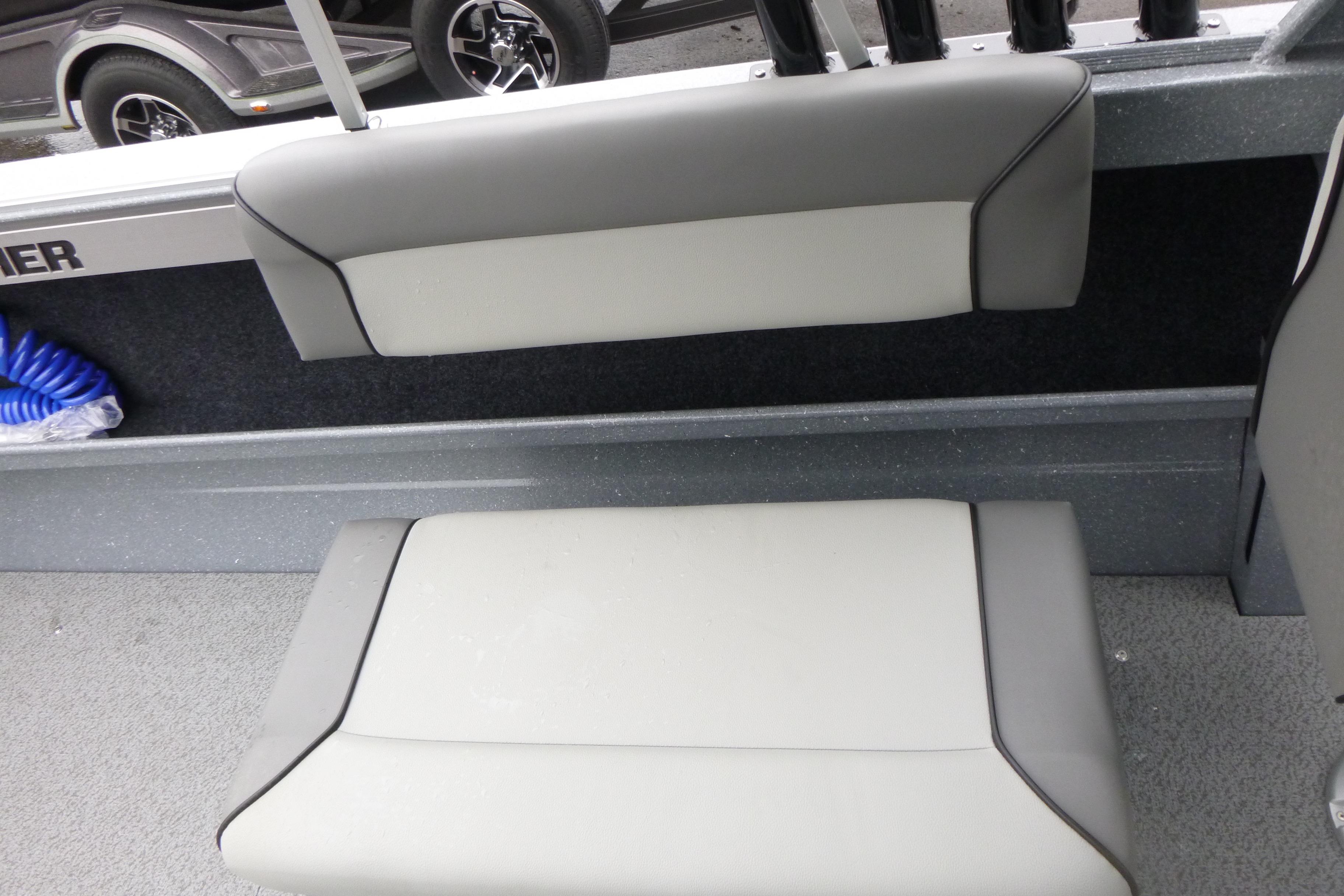Interior seating of 2026 KingFisher 2025 Escape boat, featuring gray cushioned seats.