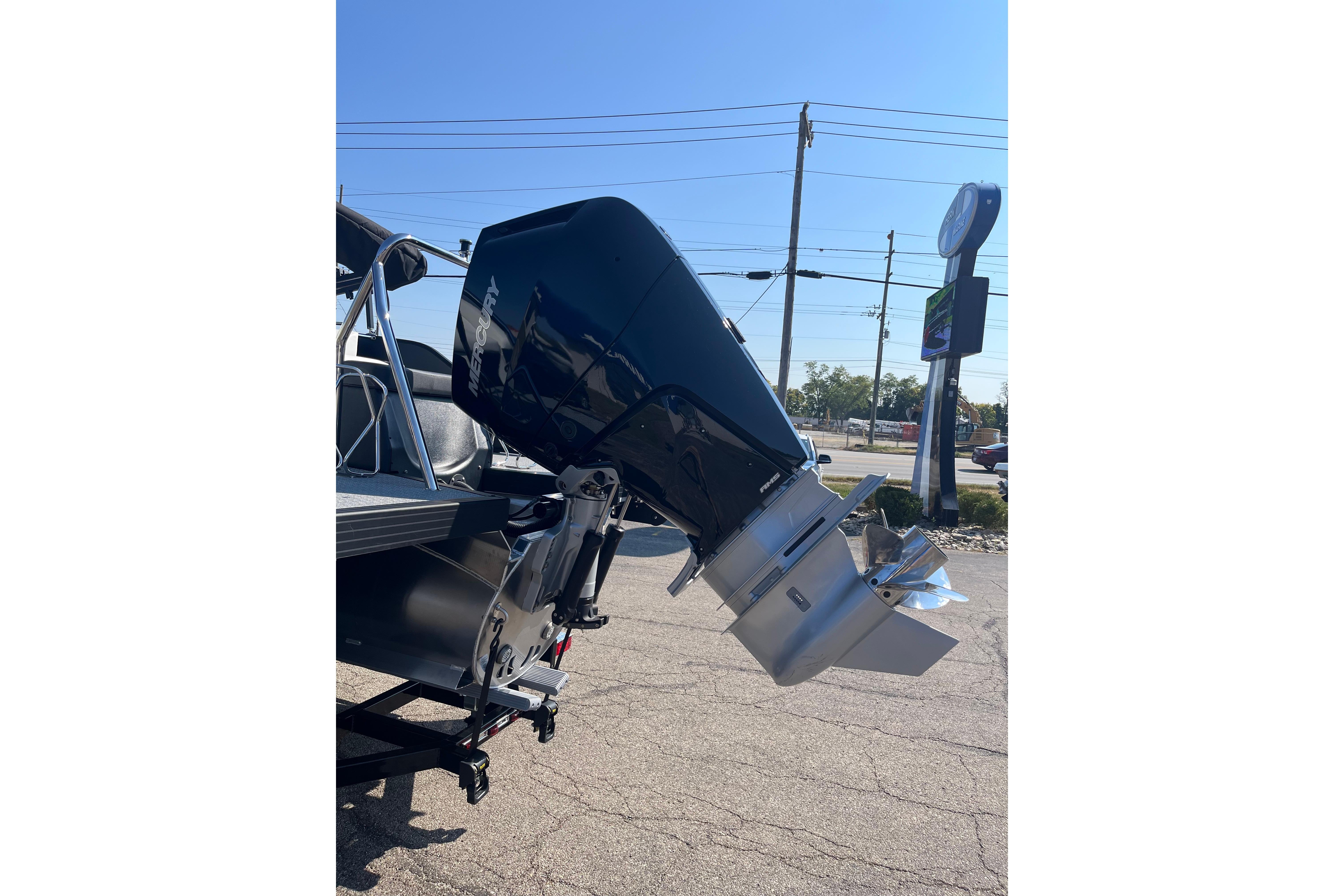 Outboard motor on Evotti 725CS boat, 2026 model, parked outdoors.