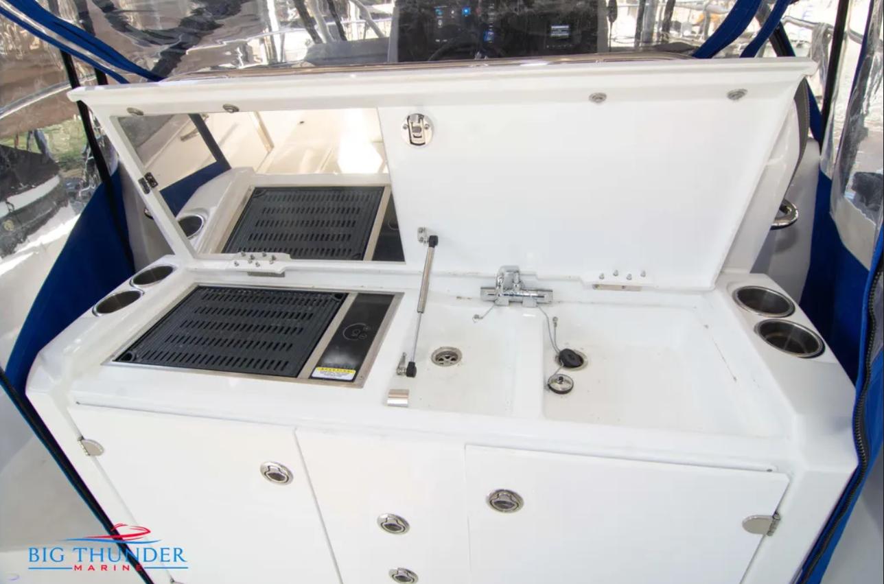 Outdoor kitchen on 2020 Jeanneau Leader 10.5 boat with grill and sink.