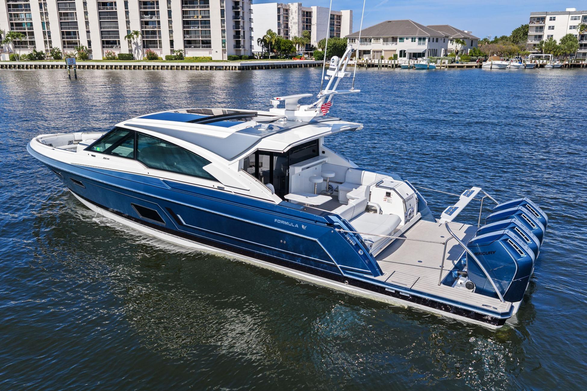 2025 Formula 500 Super Sport Crossover yacht cruising on a sunny waterfront.