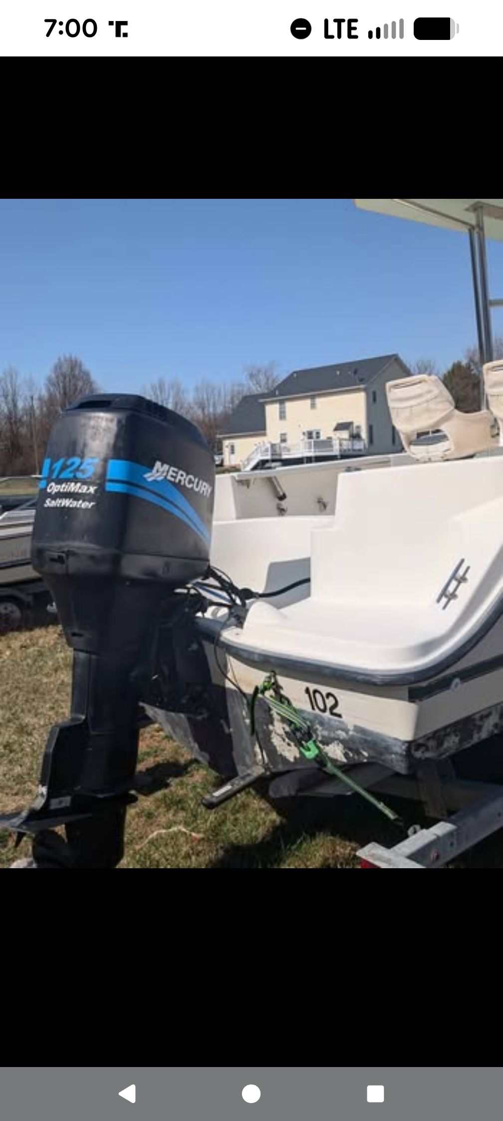 2001 Bayliner 1903 Trophy with Mercury outboard motor on grass.