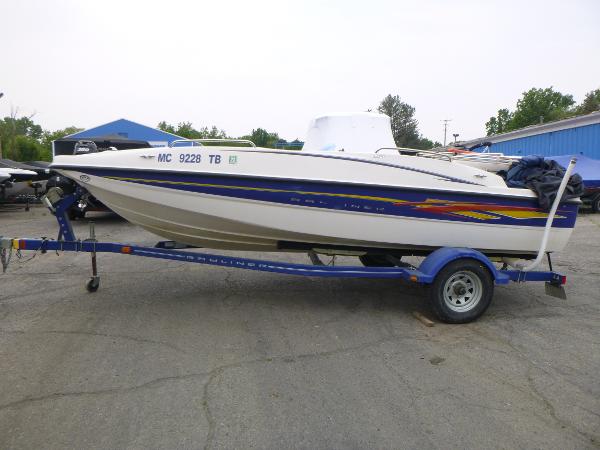 2007 Bayliner 197 Deck Boat on a blue trailer in a parking lot.