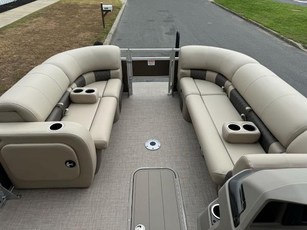 2025 Sun Tracker SportFish 22 XP3 pontoon boat with beige seating and cup holders.