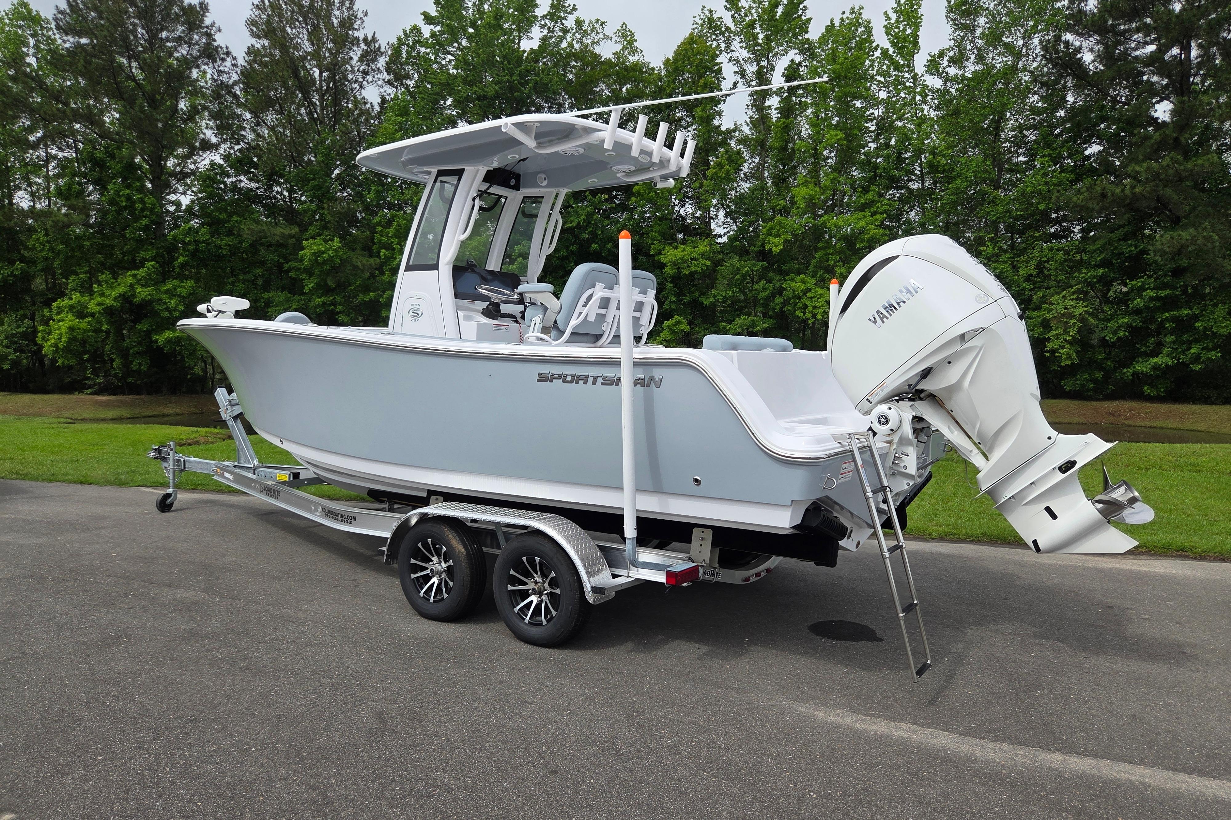 2026 Sportsman Open 232 Center Console boat on trailer, parked outdoors.