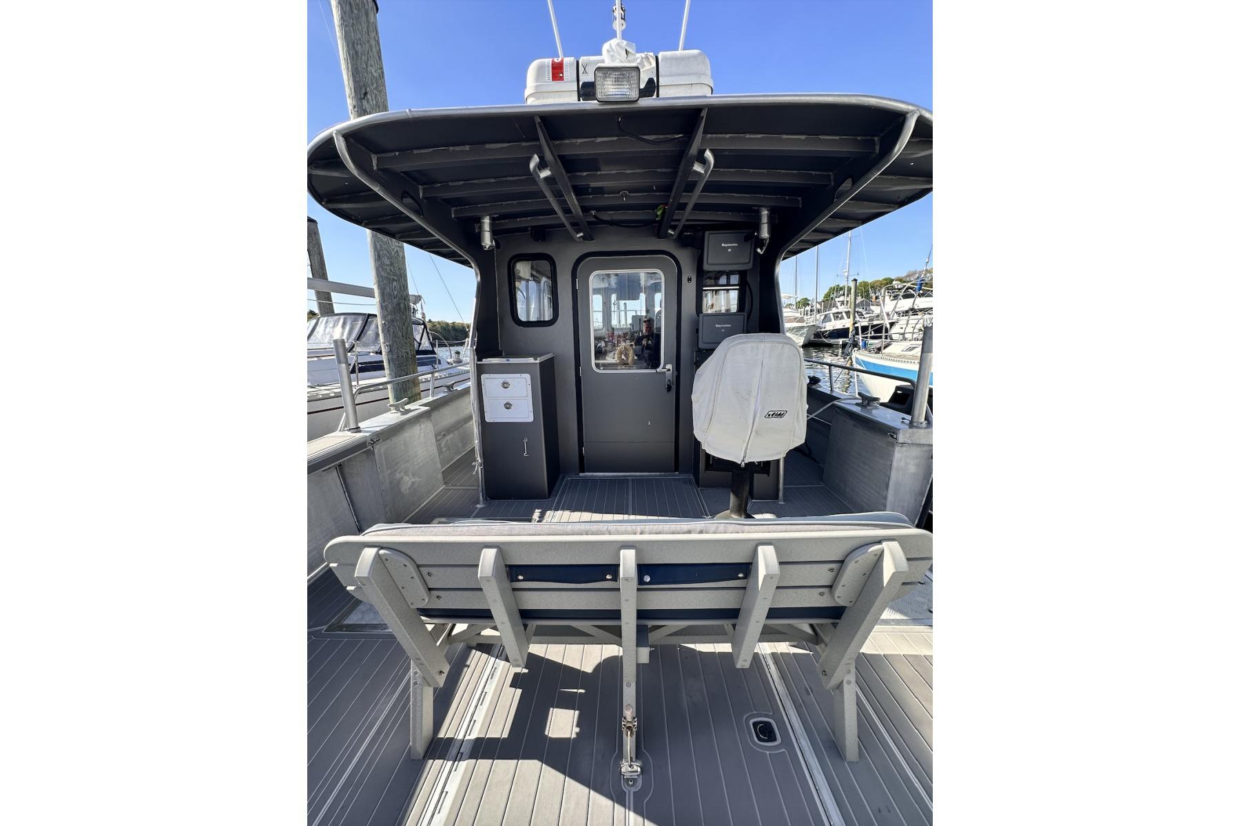 2009 Hunt 35 boat interior with seating and helm, docked at marina.