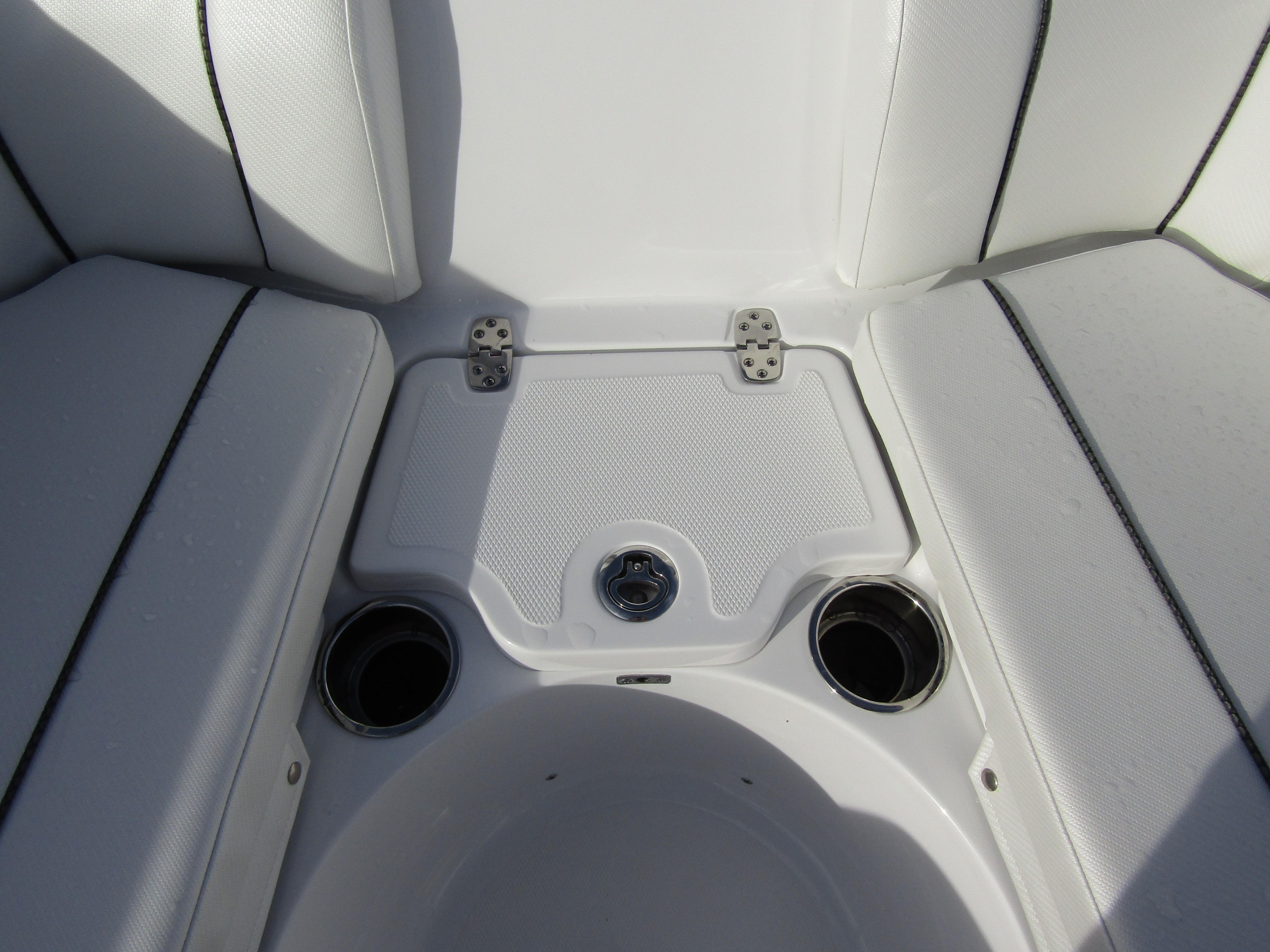 2025 Wellcraft 243 Fisherman boat seating area with cup holders and storage.
