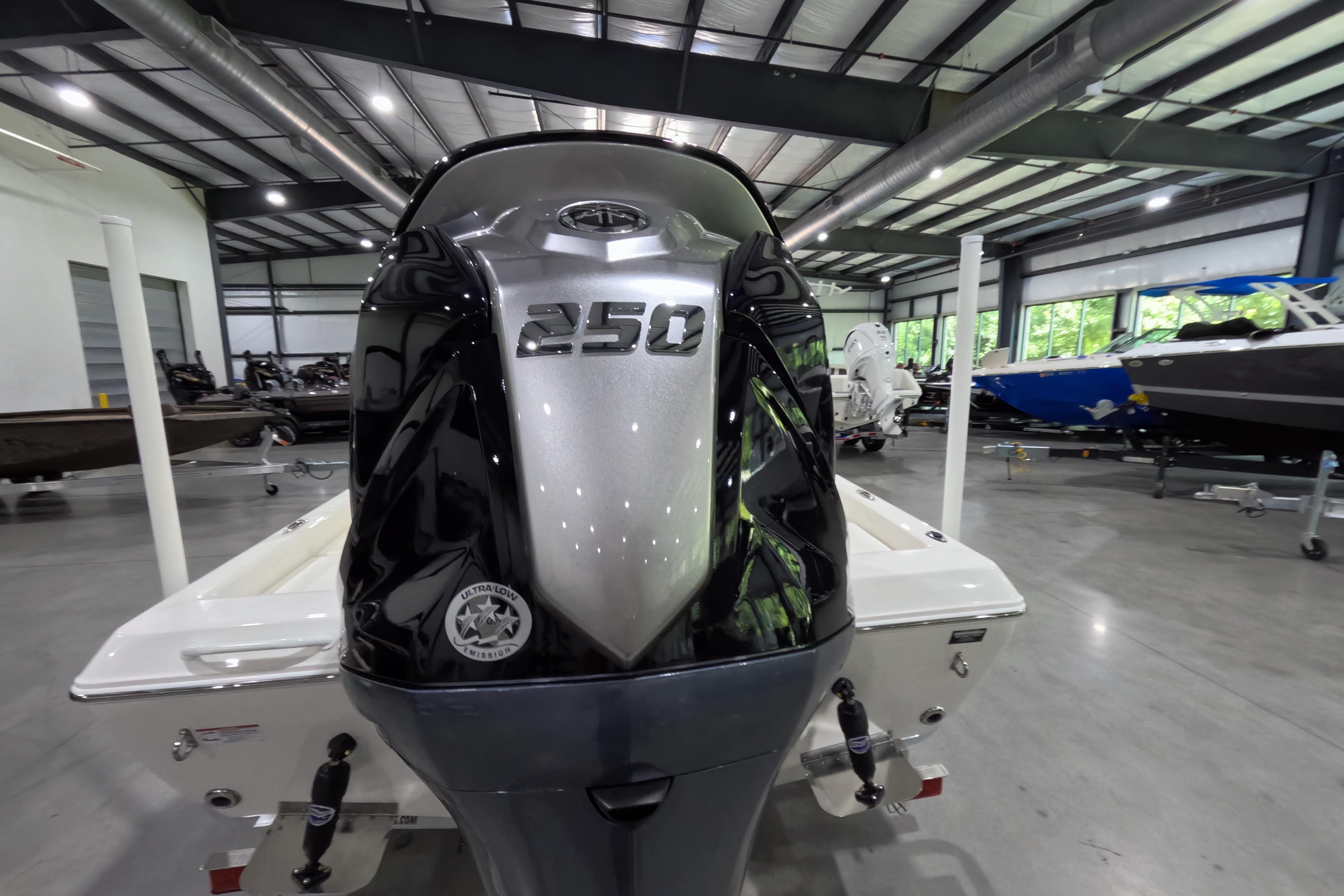 2026 Skeeter SX230 boat with powerful 250 HP engine in showroom.