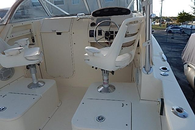 2003 World Cat 270 EC boat cockpit with dual seats and steering wheel.