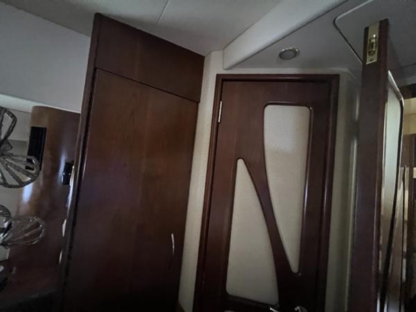 Interior of a 2009 Ovation 52 yacht with wooden cabinetry and modern door design.