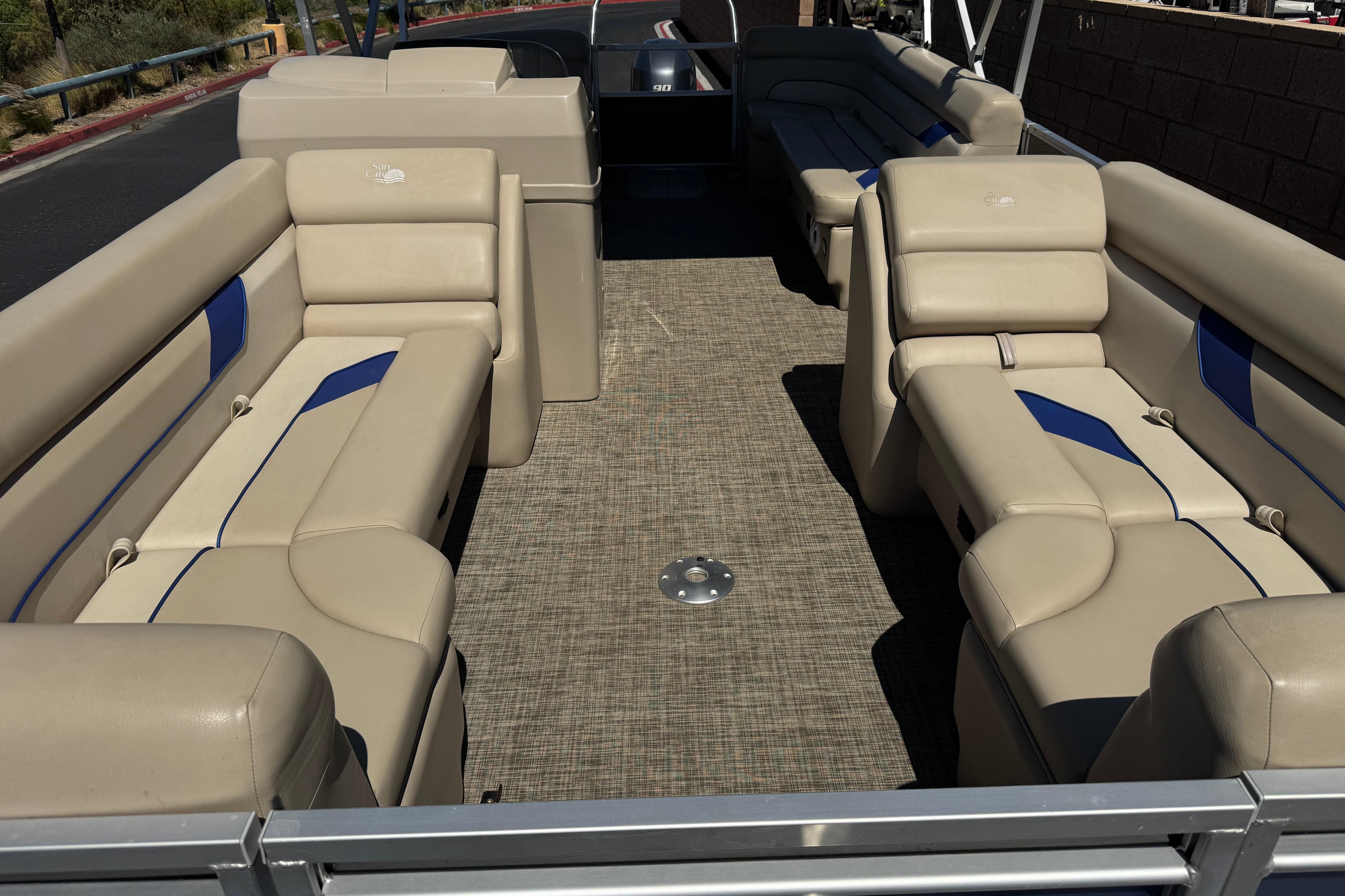 2021 SunCatcher Select 20RCX pontoon boat interior with beige seating and blue accents.