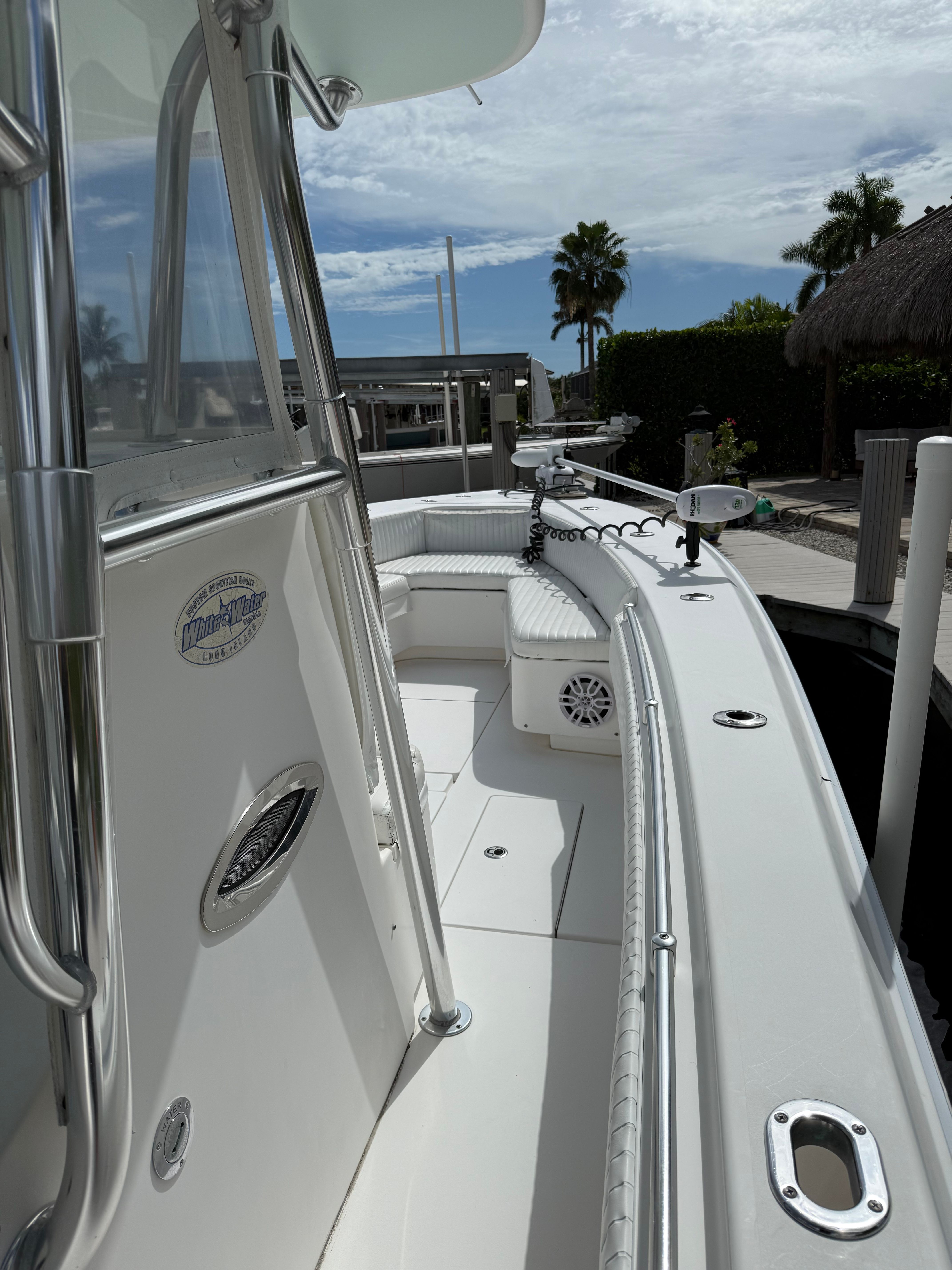 2012 Contender 32 ST boat docked under sunny skies.