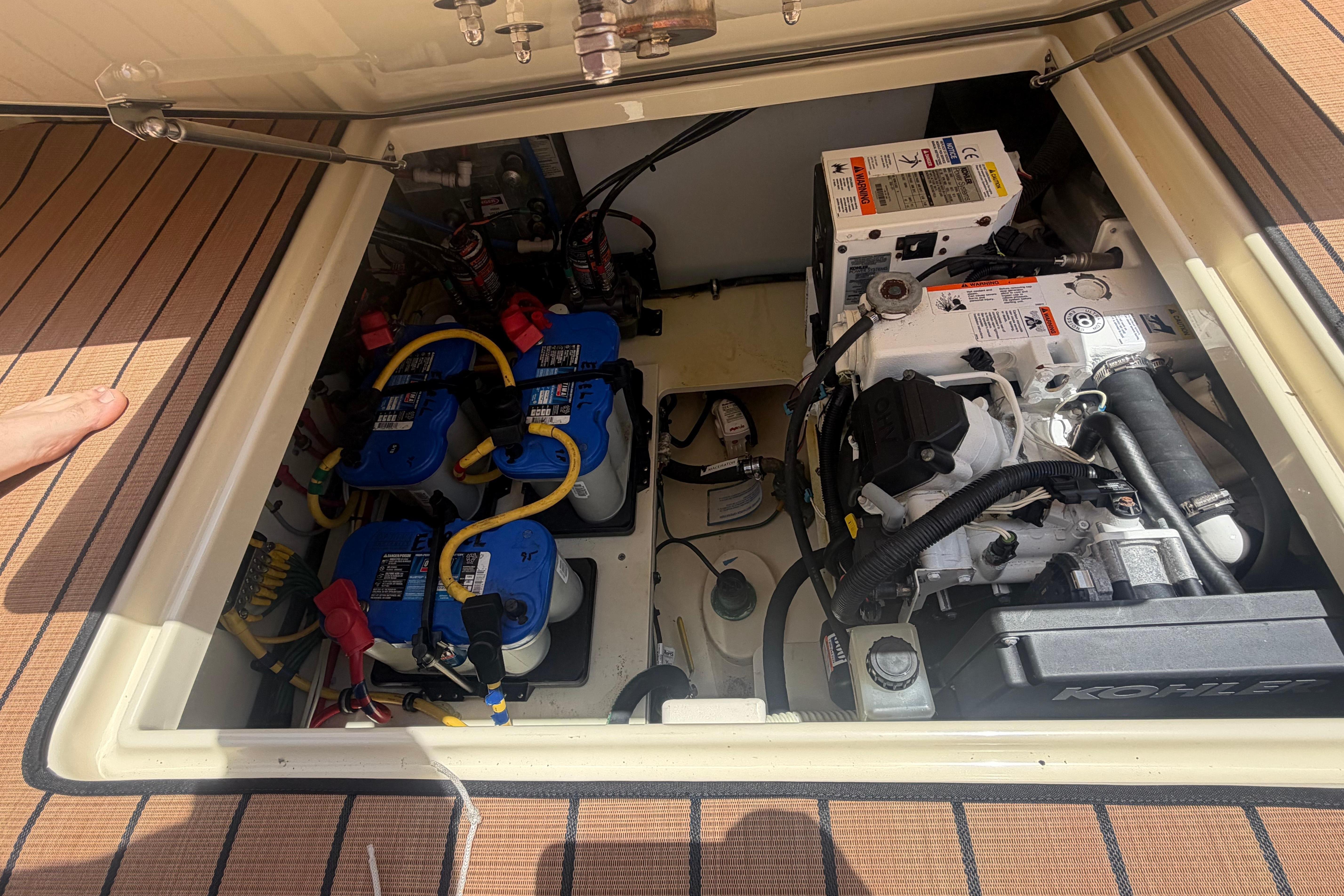 Engine compartment of a 2017 Chris-Craft Catalina 34, showcasing mechanical components and wiring.