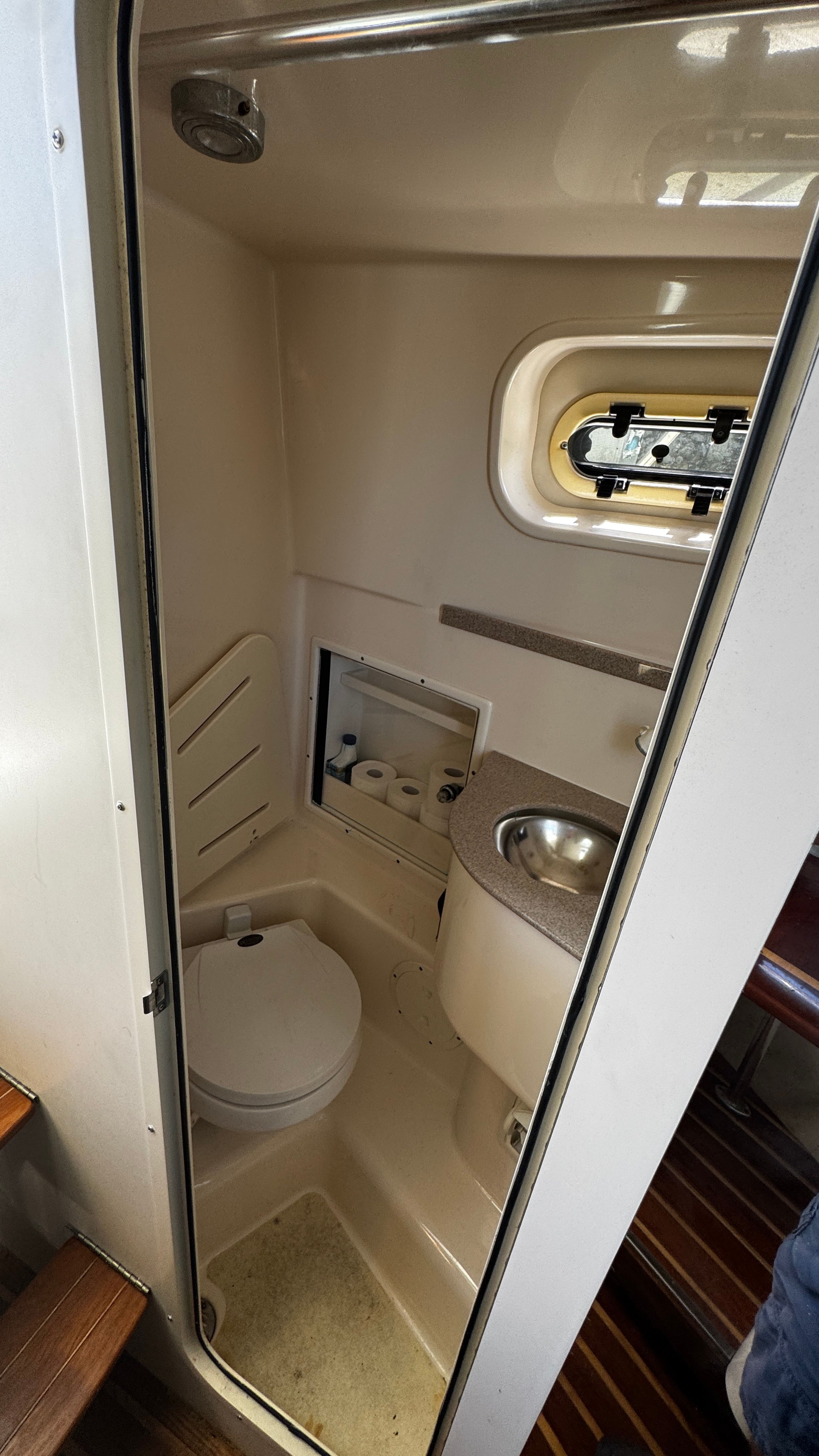 Bathroom in a 2003 Pursuit 3070 with toilet and sink.