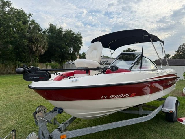 2012 Bayliner 184 SF boat on trailer, red and white design.