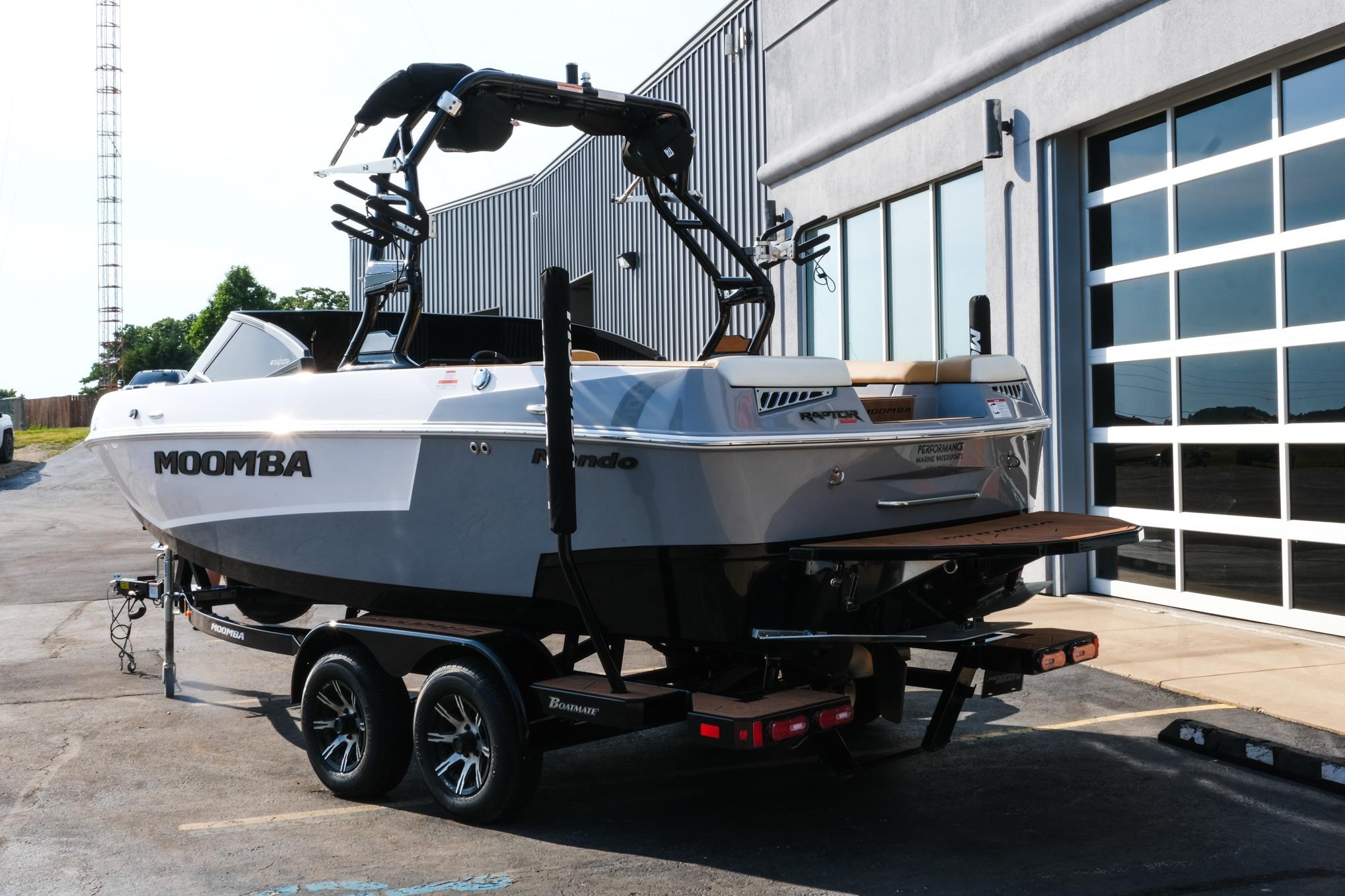 2023 Moomba Mondo boat on trailer outside a modern building.